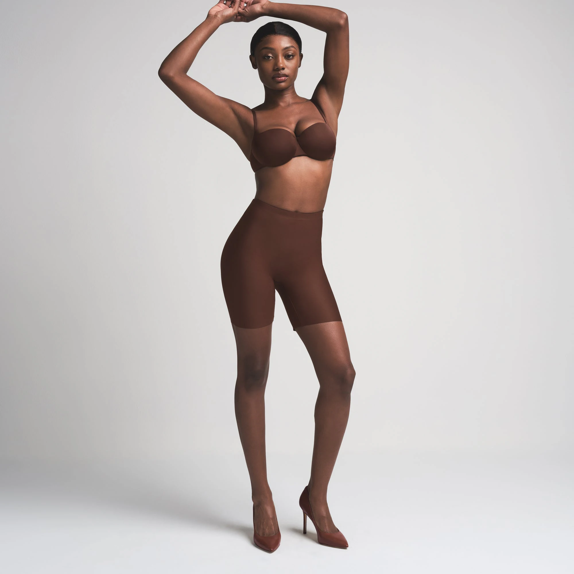 SKIMS BODY BUTT ENHANCING PADDED SHORT | COCOA ON A MODEL FRONT VIEW | FOCUS: 0.0, 1.0, 0.9