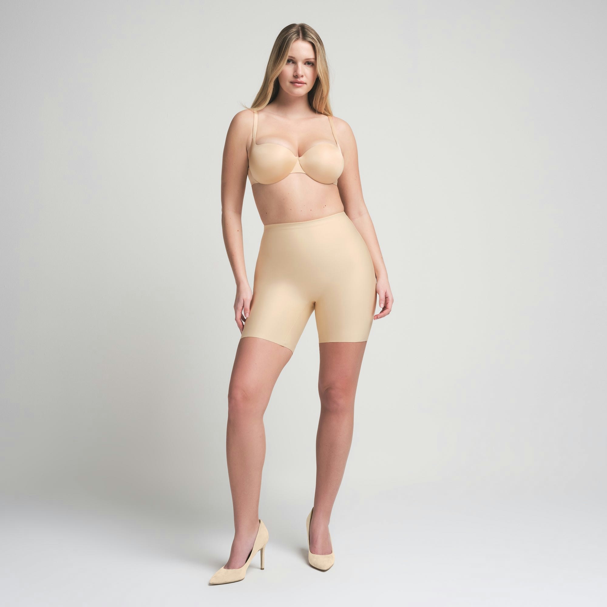 SKIMS BODY BUTT ENHANCING PADDED SHORT | SAND ON A MODEL FRONT VIEW