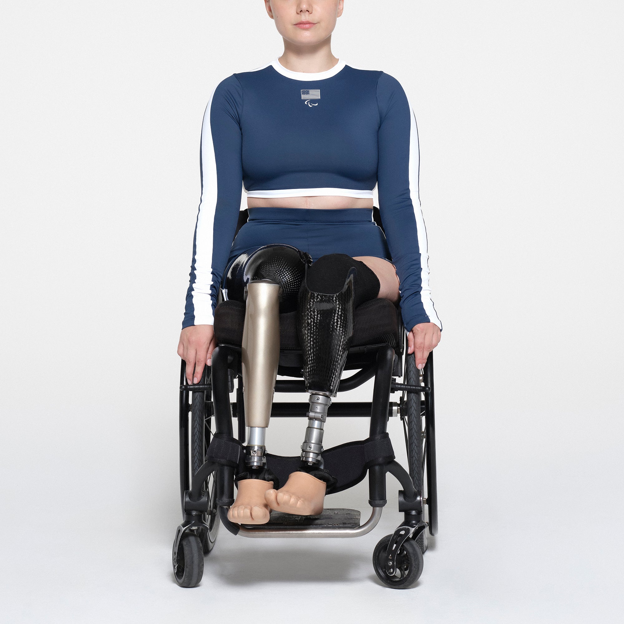 SKIMS FOR TEAM USA SIGNATURE SWIM PARALYMPIC MID WAIST SHORT | NAVY ON A MODEL FRONT VIEW | FOCUS: 0.1, 1, 0.9