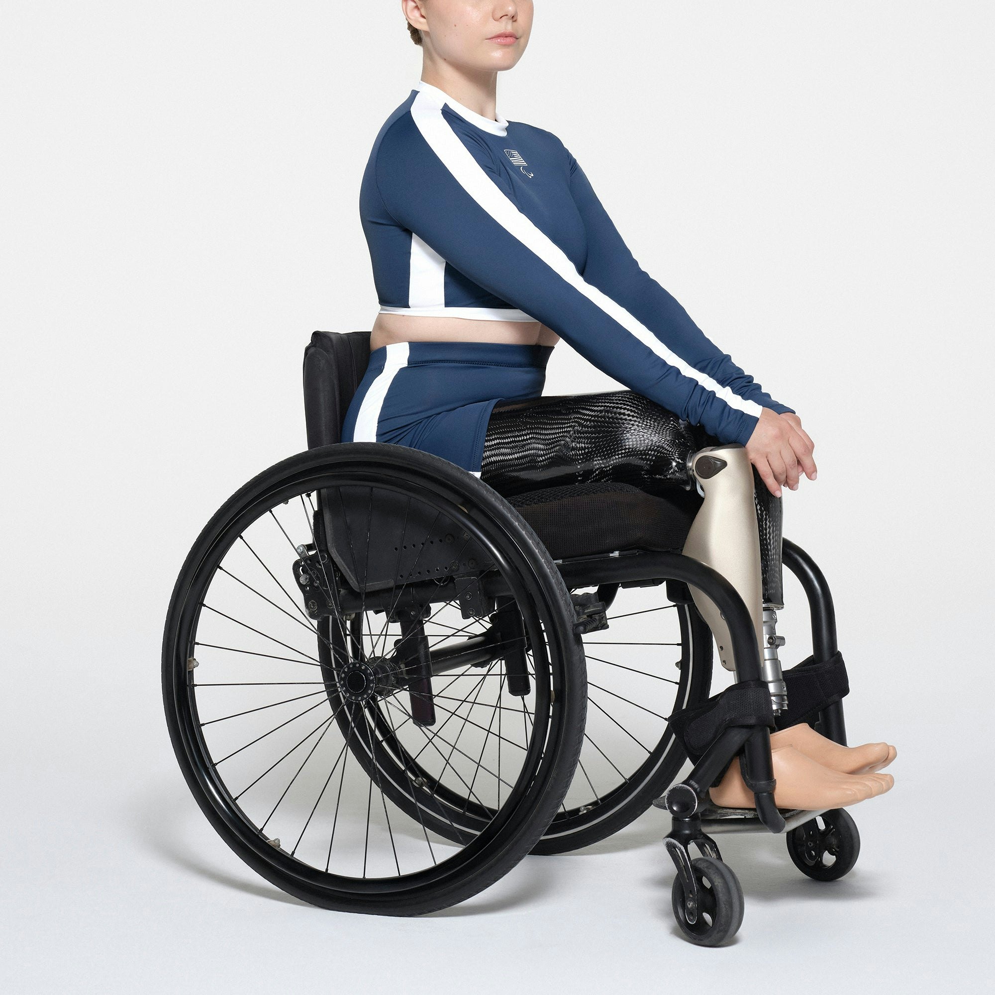 SKIMS FOR TEAM USA SIGNATURE SWIM PARALYMPIC MID WAIST SHORT | NAVY ON A MODEL SIDE VIEW