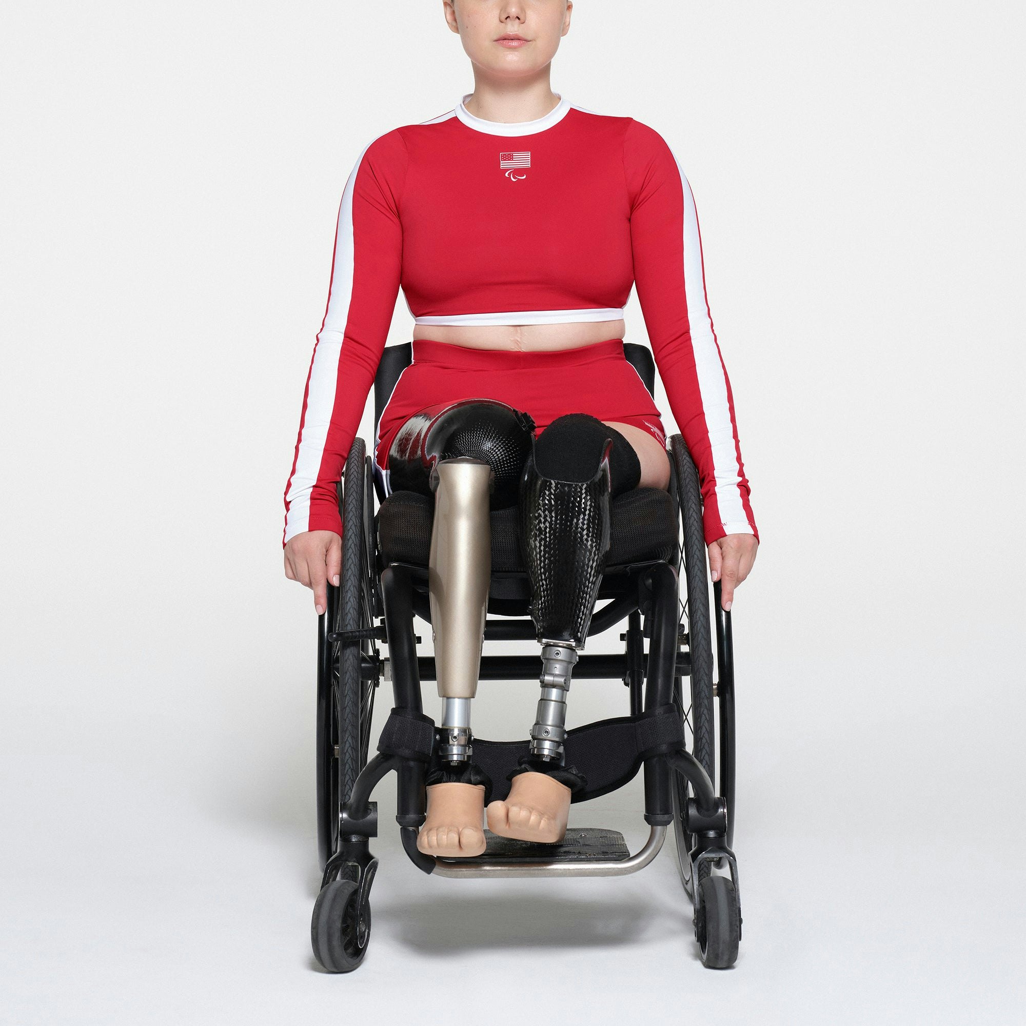 SKIMS FOR TEAM USA SIGNATURE SWIM PARALYMPIC MID WAIST SHORT | RED ON A MODEL FRONT VIEW | FOCUS: 0.1, 1, 0.9