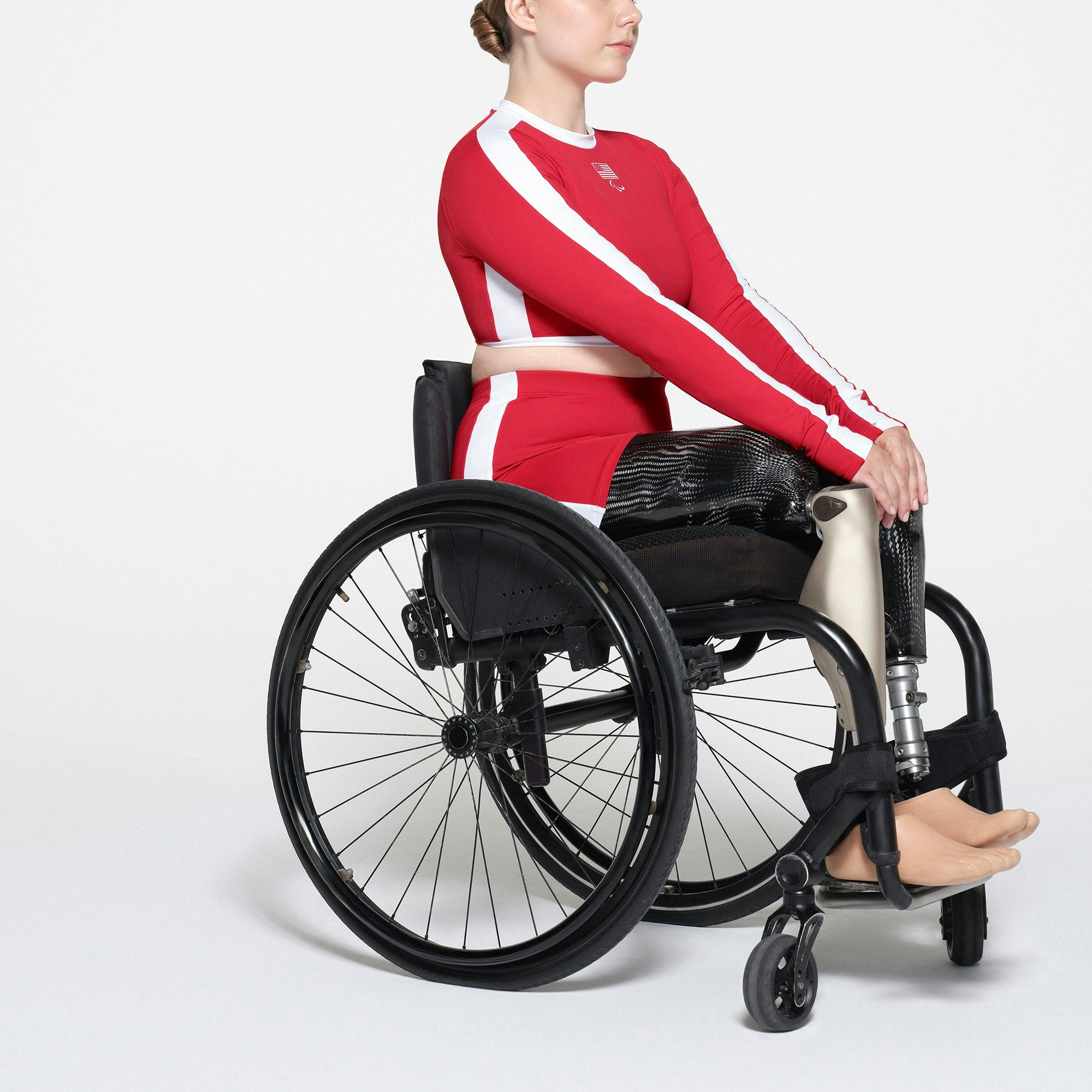 SKIMS FOR TEAM USA SIGNATURE SWIM PARALYMPIC MID WAIST SHORT | RED ON A MODEL SIDE VIEW