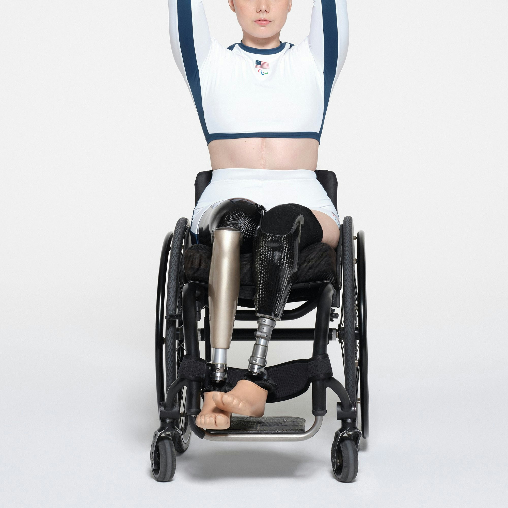 SKIMS FOR TEAM USA SIGNATURE SWIM PARALYMPIC MID WAIST SHORT | WHITE ON A MODEL FRONT VIEW | FOCUS: 0.1, 1, 0.9