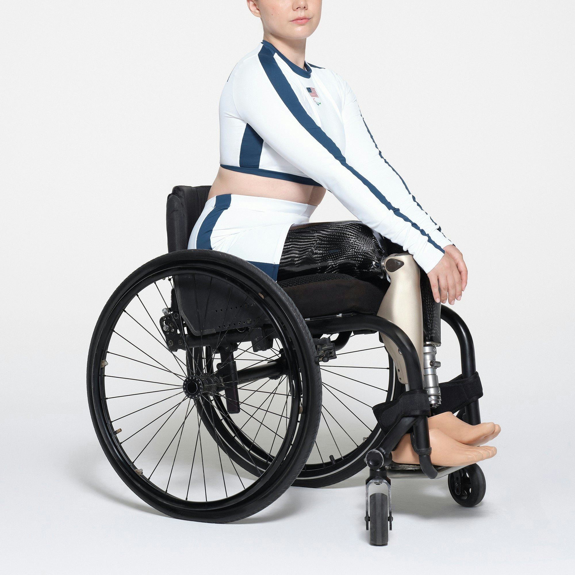 SKIMS FOR TEAM USA SIGNATURE SWIM PARALYMPIC MID WAIST SHORT | WHITE ON A MODEL SIDE VIEW