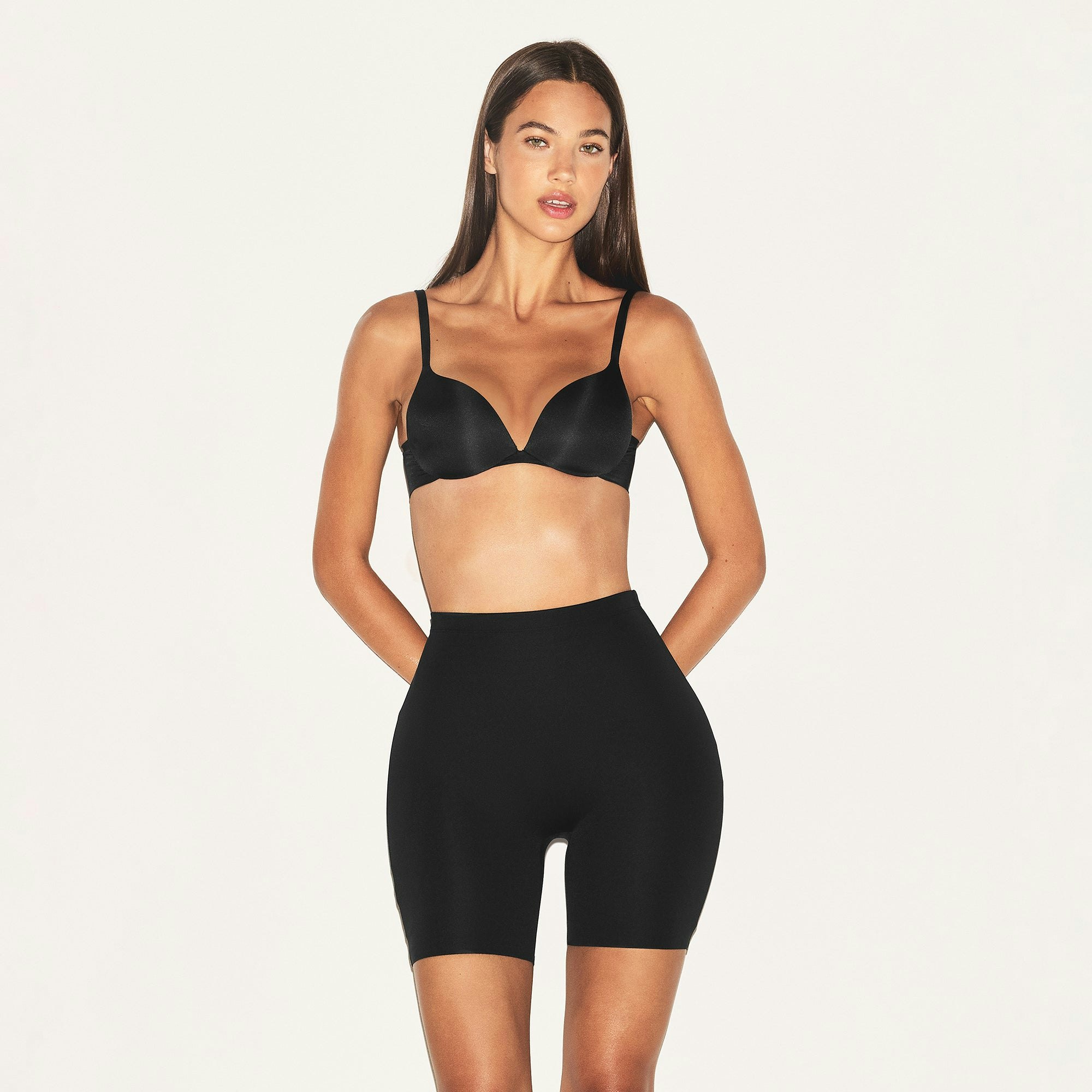 SKIMS BODY HIP ENHANCING PADDED SHORT | ONYX ON A MODEL FRONT VIEW | FOCUS: 0.0, 1.0, 0.9