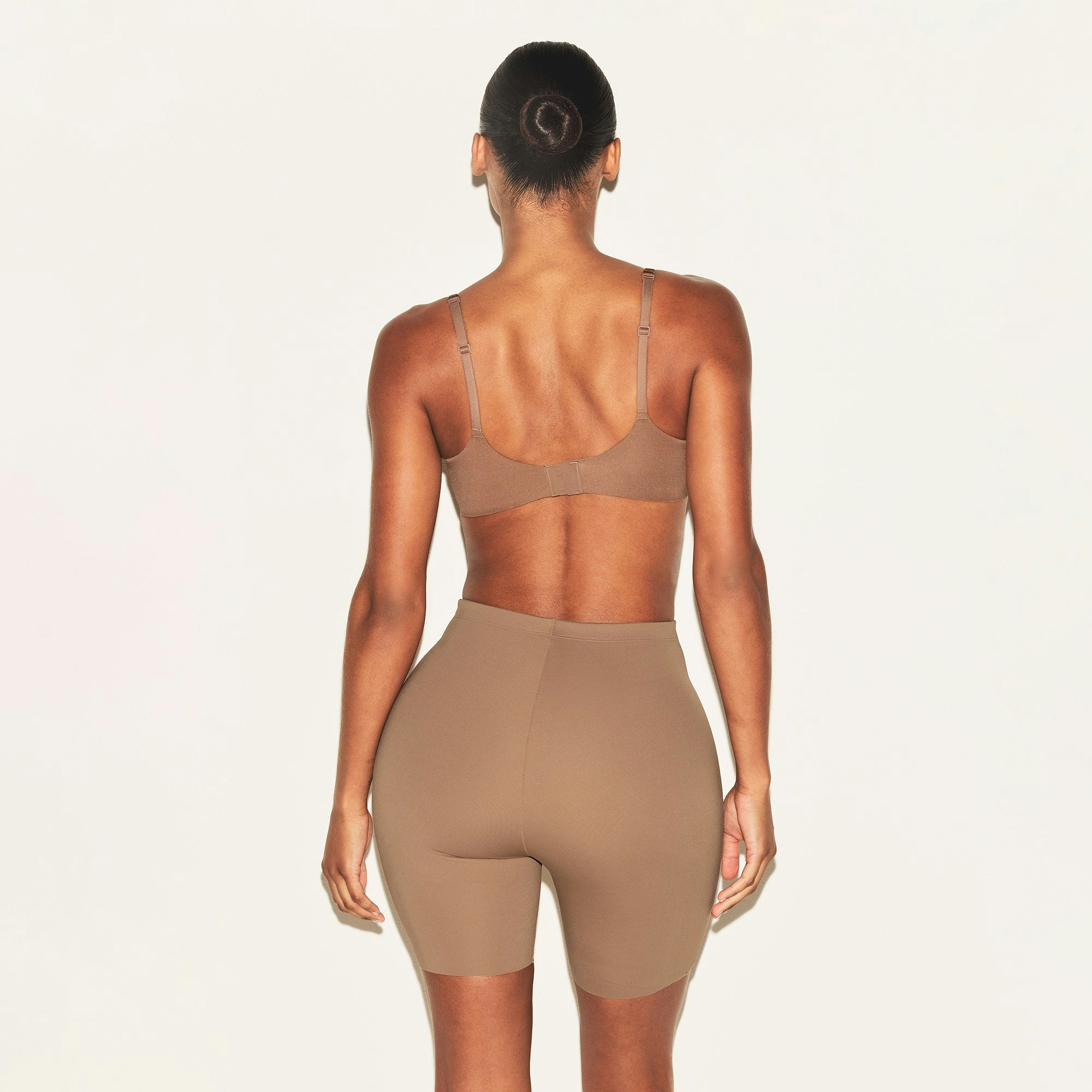 SKIMS BODY HIP ENHANCING PADDED SHORT | SIENNA ON A MODEL BACK VIEW | FOCUS: 0.0, 1.0, 0.9