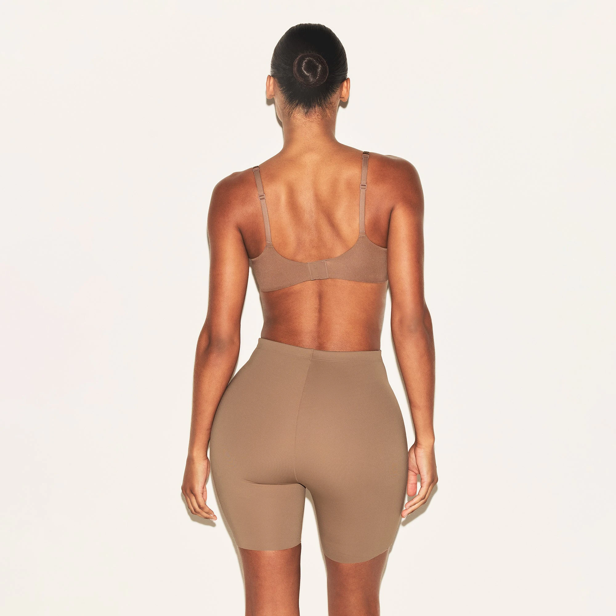 SKIMS BODY HIP ENHANCING PADDED SHORT | SIENNA ON A MODEL BACK VIEW | FOCUS: 0.0, 1.0, 0.9