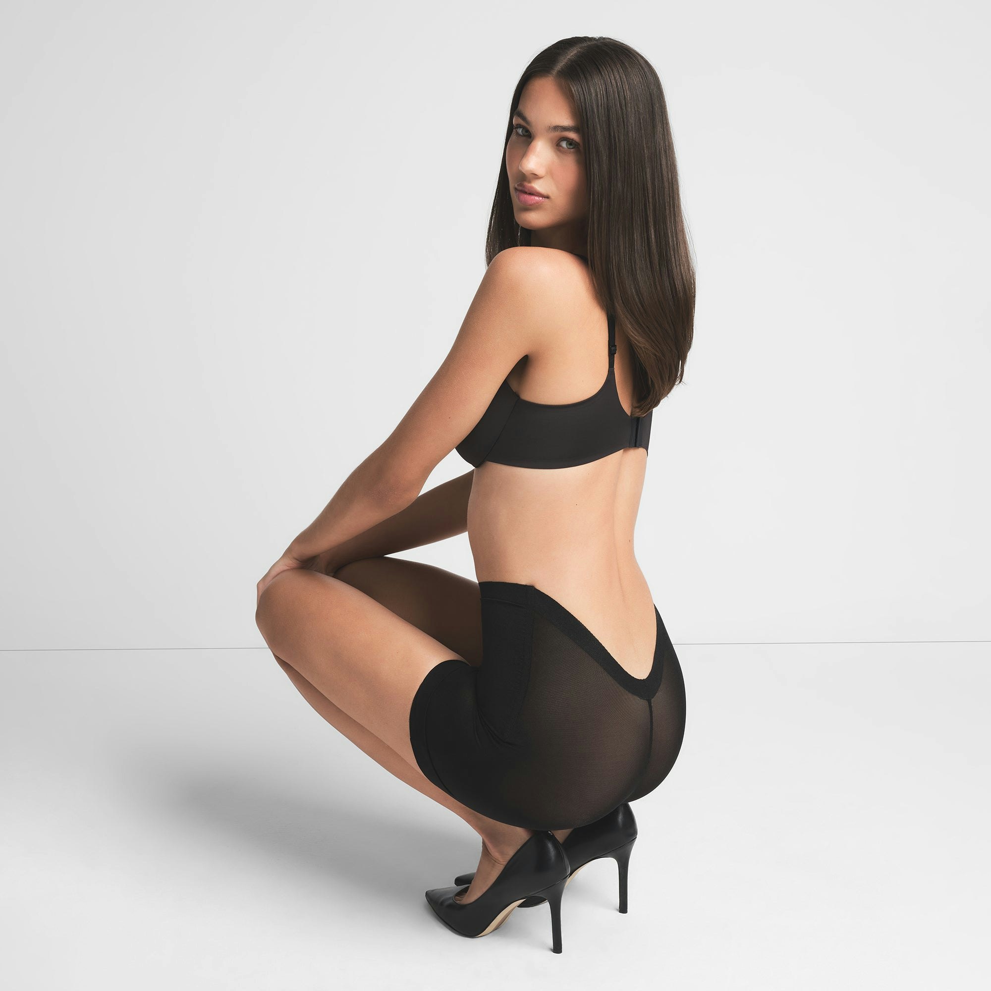SHEER SCULPT LOW BACK SHORT | ONYX ON A MODEL BACK VIEW