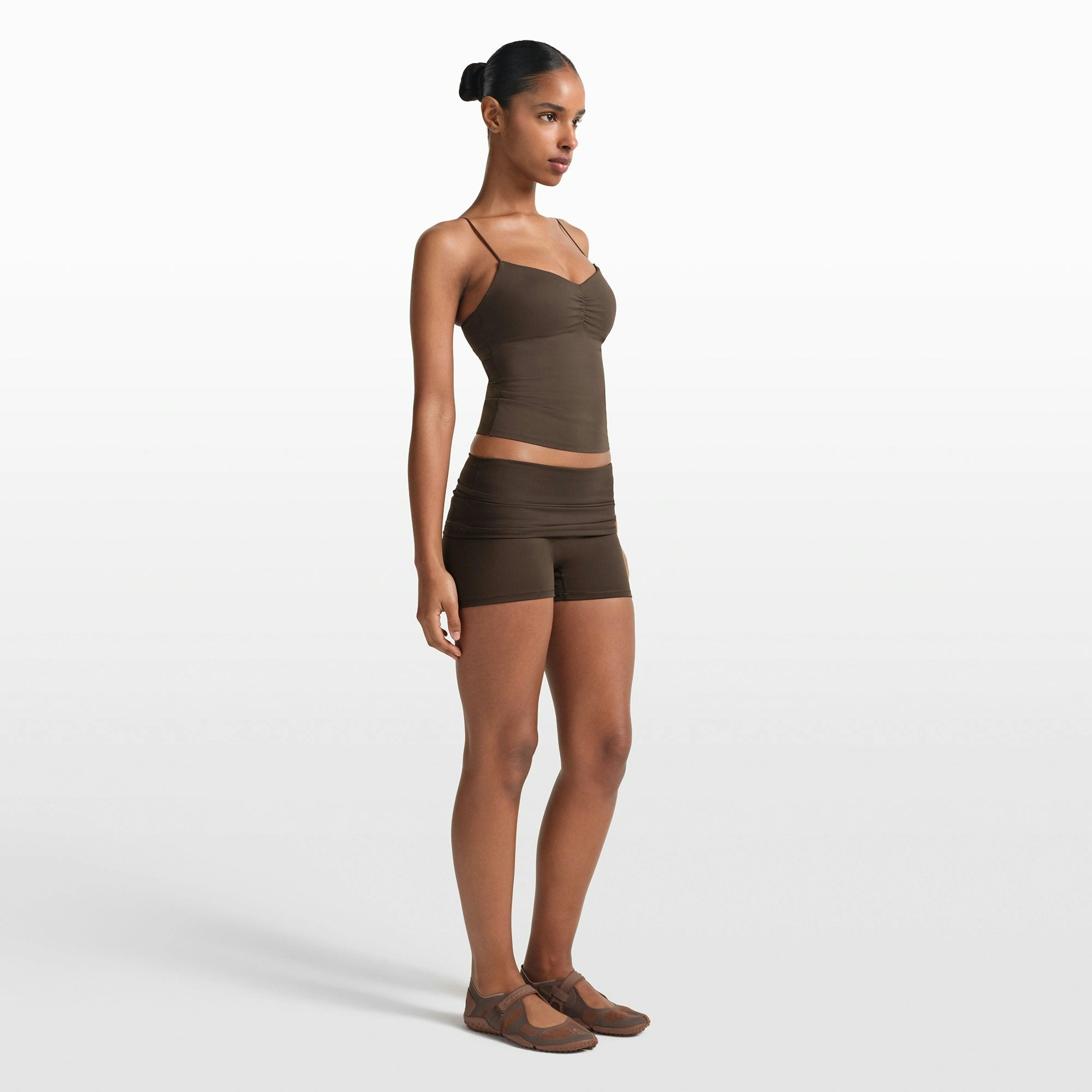 NikeSKIMS MATTE 3" FOLDOVER SHORT | DARK SEPIA ON A MODEL FRONT VIEW @ | FOCUS: 0.0, 1.0, 0.9