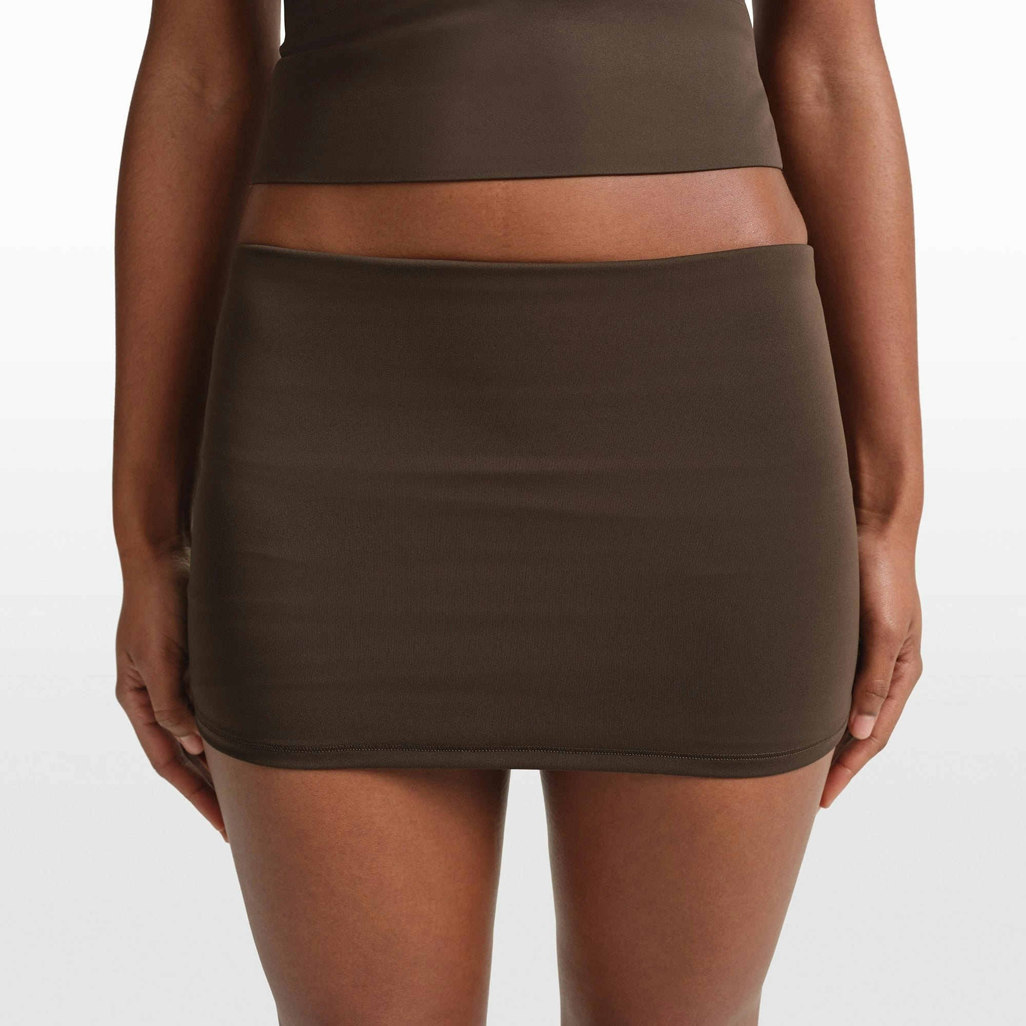 NikeSKIMS MATTE 3" FOLDOVER SHORT | DARK SEPIA ON A MODEL FRONT VIEW @ | FOCUS: 0.0, 1.0, 0.9