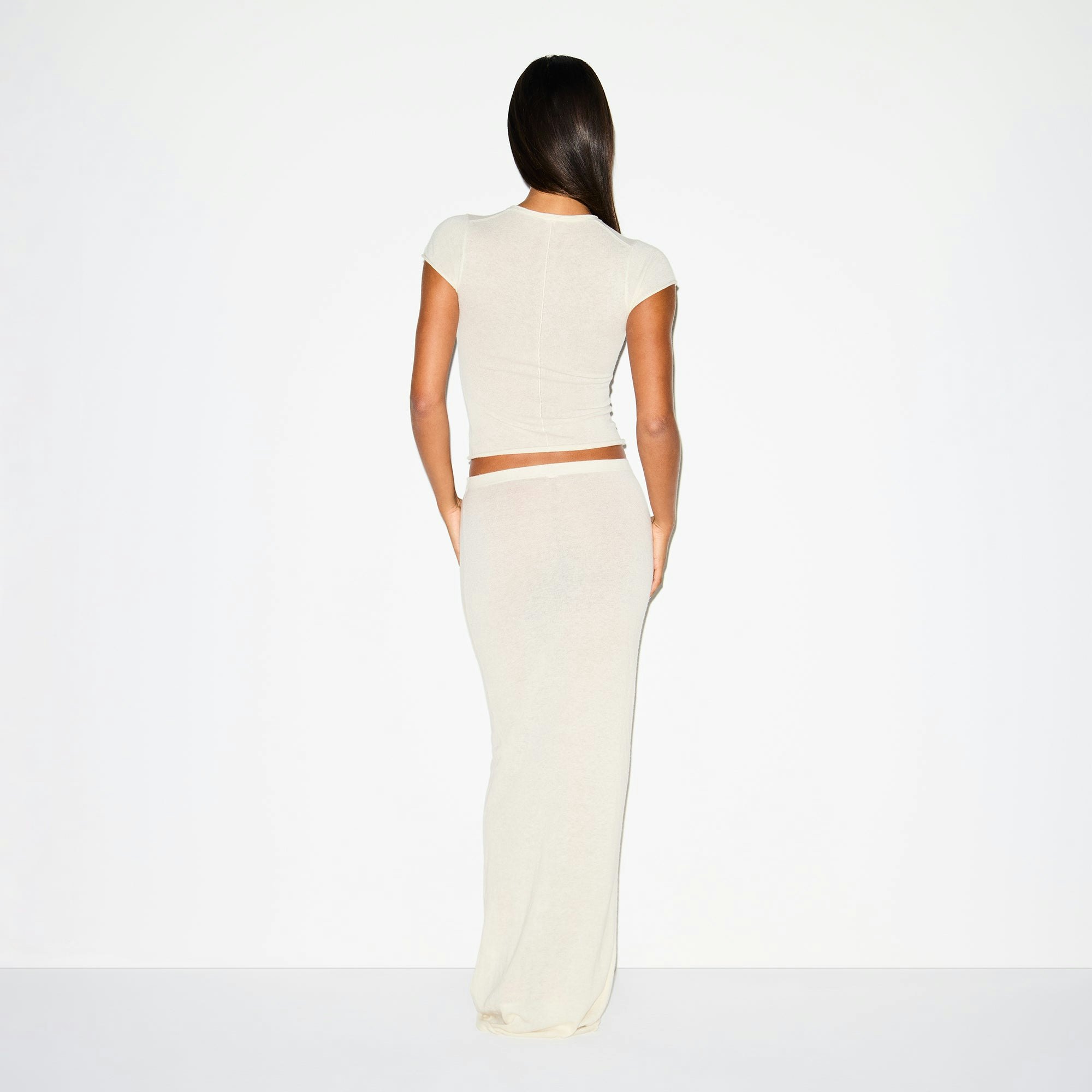 FEATHERWEIGHT CASHMERE LONG SKIRT | EGRET ON A MODEL BACK VIEW @ | FOCUS: 0.0, 1.0, 0.9