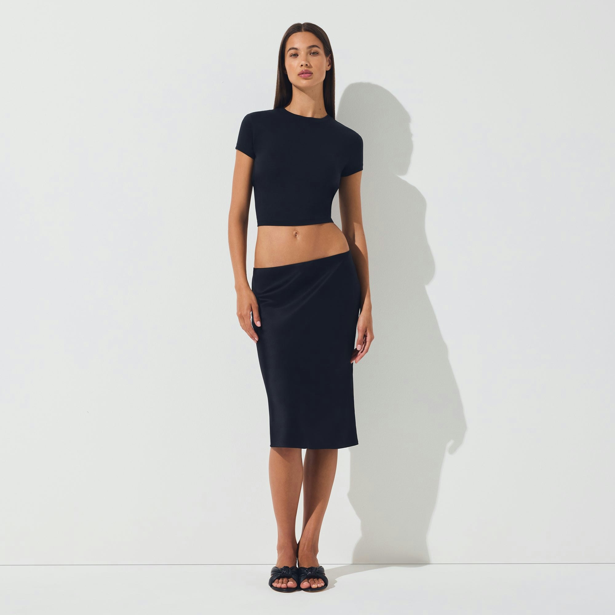 SILK MIDI SKIRT | ONYX ON A MODEL FRONT VIEW | FOCUS: 0.0, 1.0, 0.9