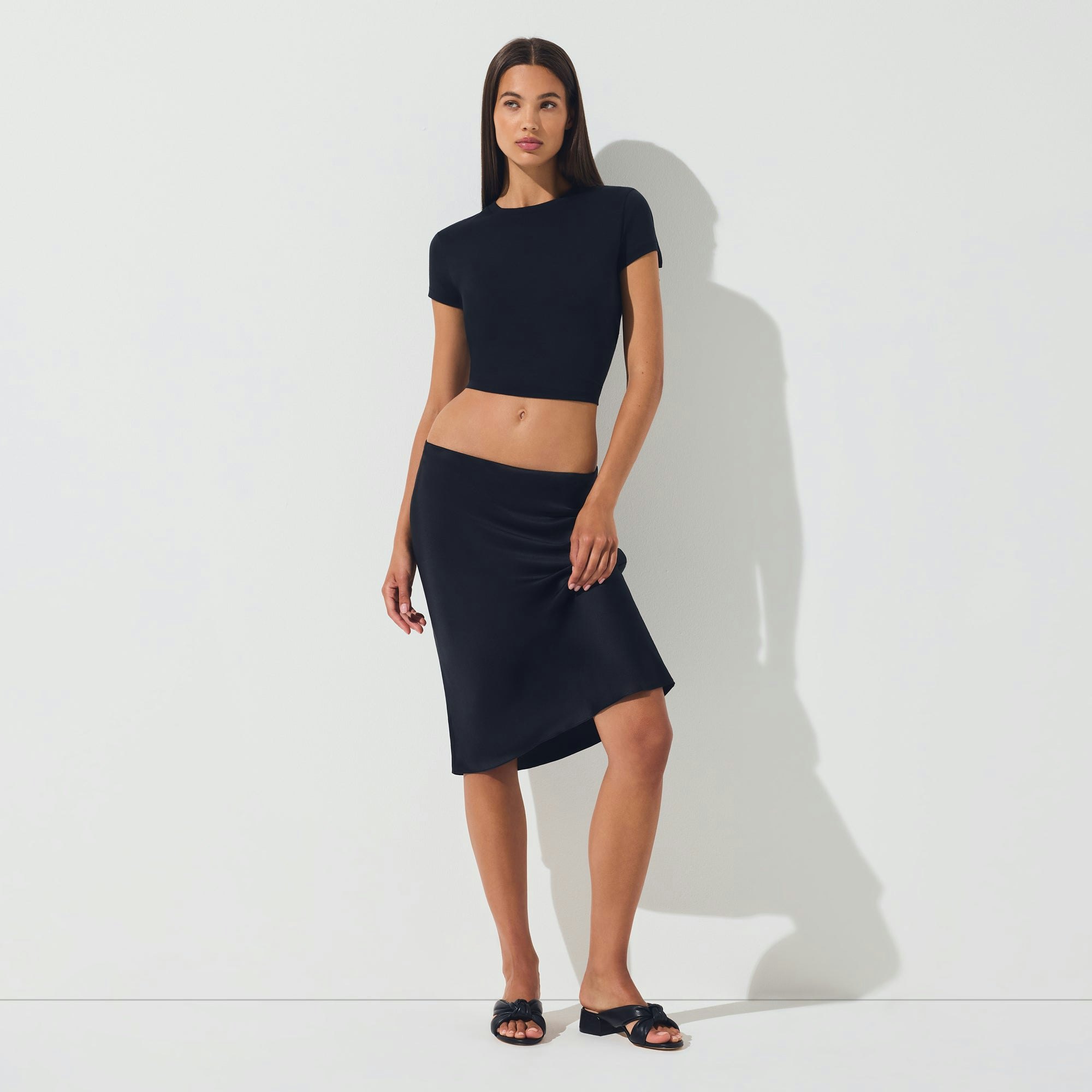 SILK MIDI SKIRT | ONYX ON A MODEL FRONT VIEW | FOCUS: 0.0, 1.0, 0.9