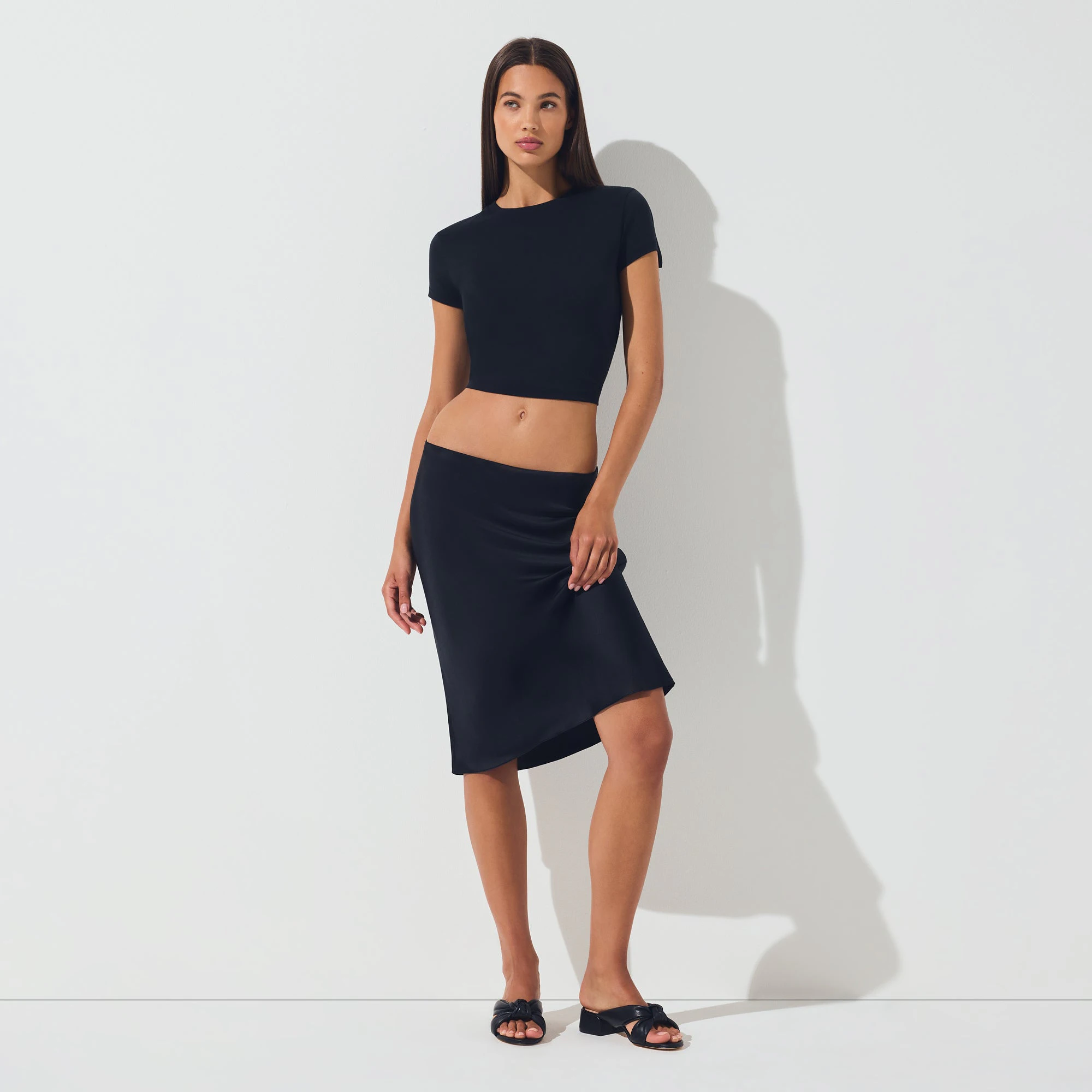SILK MIDI SKIRT | ONYX ON A MODEL FRONT VIEW | FOCUS: 0.0, 1.0, 0.9
