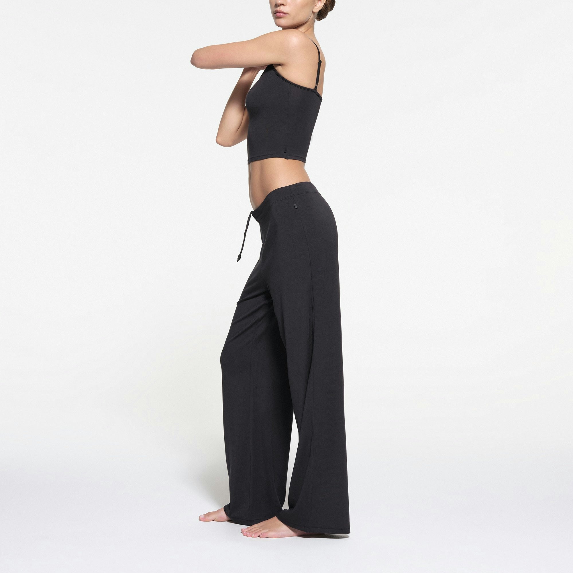 SKIMS SLEEP STRAIGHT LEG PANT | ONYX ON A MODEL SIDE VIEW