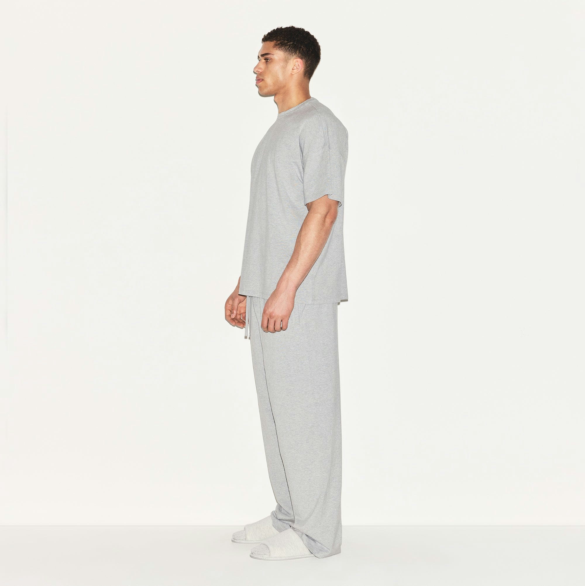 JERSEY LOUNGE MENS RELAXED STRAIGHT LEG PANT | HEATHER GREY ON A MODEL SIDE VIEW | FOCUS: 0.0, 1.0, 0.9