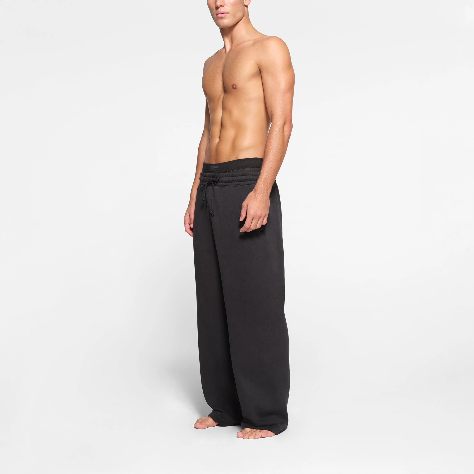 LOUNGE FLEECE MENS RELAXED STRAIGHT LEG JOGGER | WASHED ONYX ON A MODEL SIDE VIEW