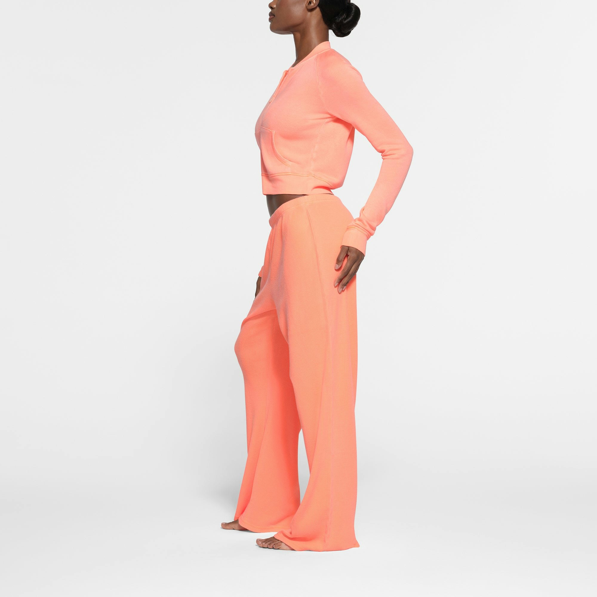 WAFFLE LOOSE PANT | NEON ORANGE ON A MODEL SIDE VIEW