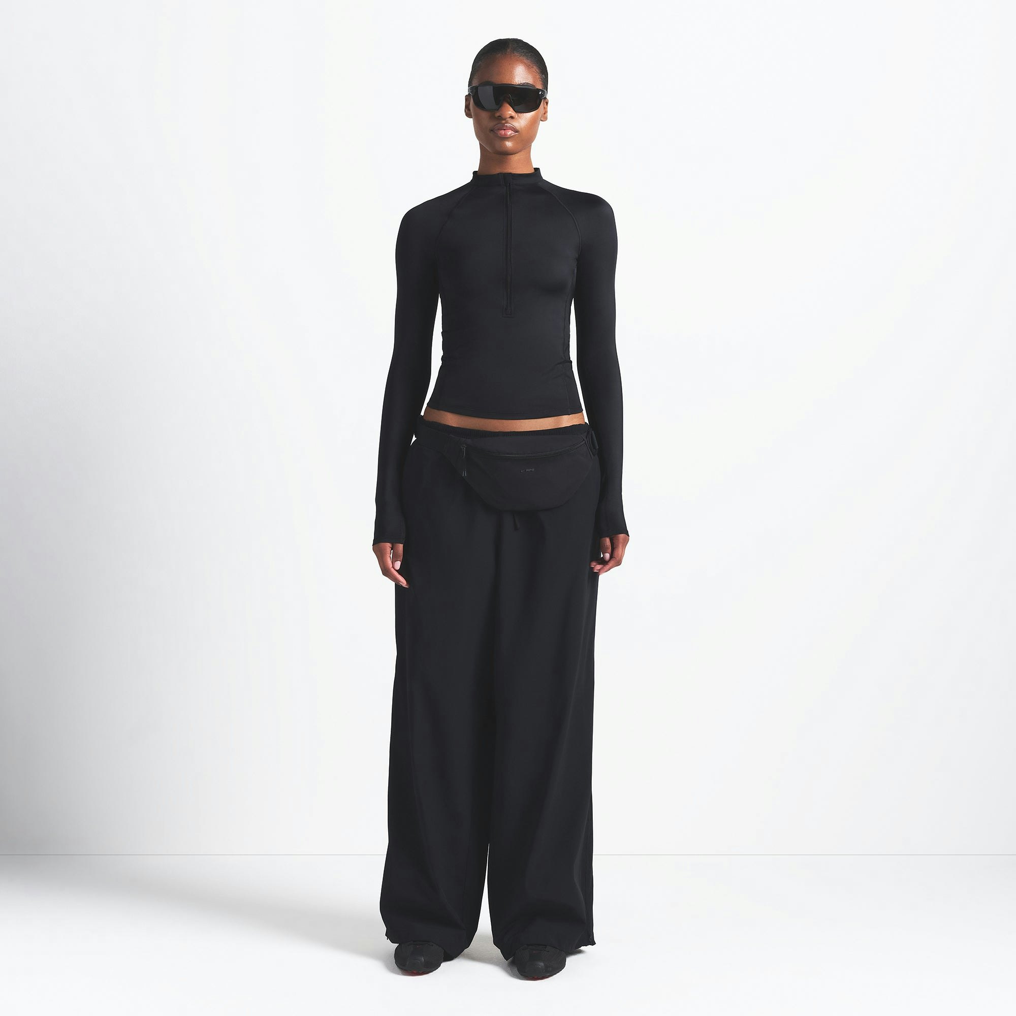 NikeSKIMS WOVEN NYLON OVERSIZED TRACK PANT | OBSIDIAN ON A MODEL FRONT VIEW @ | FOCUS: 0.0, 1.0, 0.9