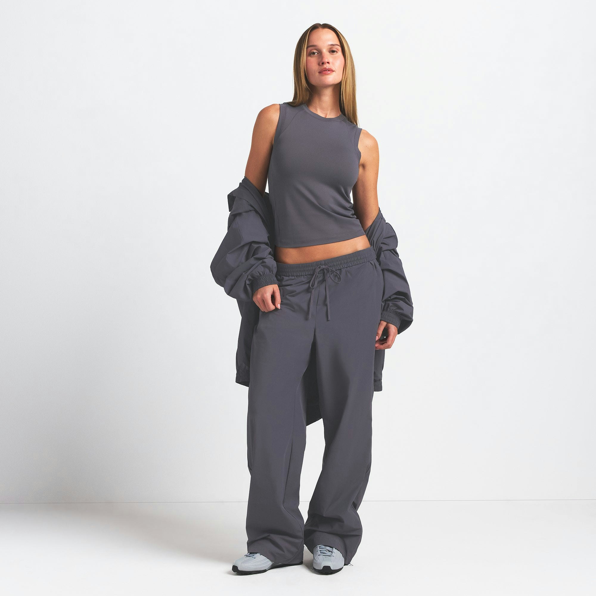 NikeSKIMS WOVEN NYLON OVERSIZED TRACK PANT | RAVEN ON A MODEL FRONT VIEW @ | FOCUS: 0.0, 1.0, 0.9
