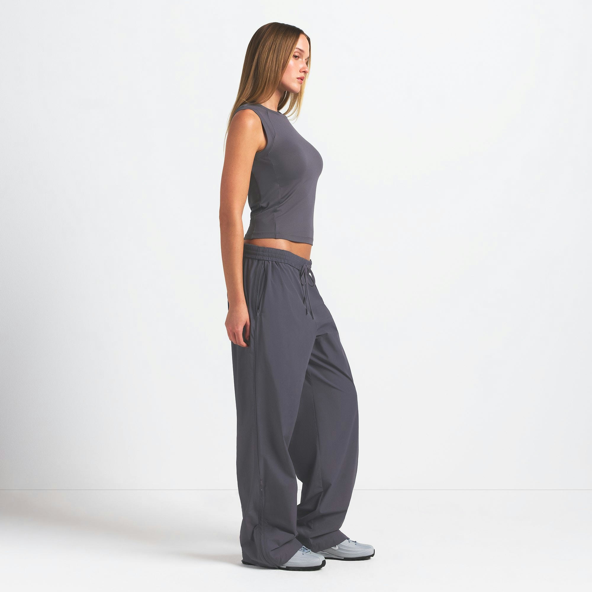 NikeSKIMS WOVEN NYLON OVERSIZED TRACK PANT | RAVEN ON A MODEL SIDE VIEW @ | FOCUS: 0.0, 1.0, 0.9