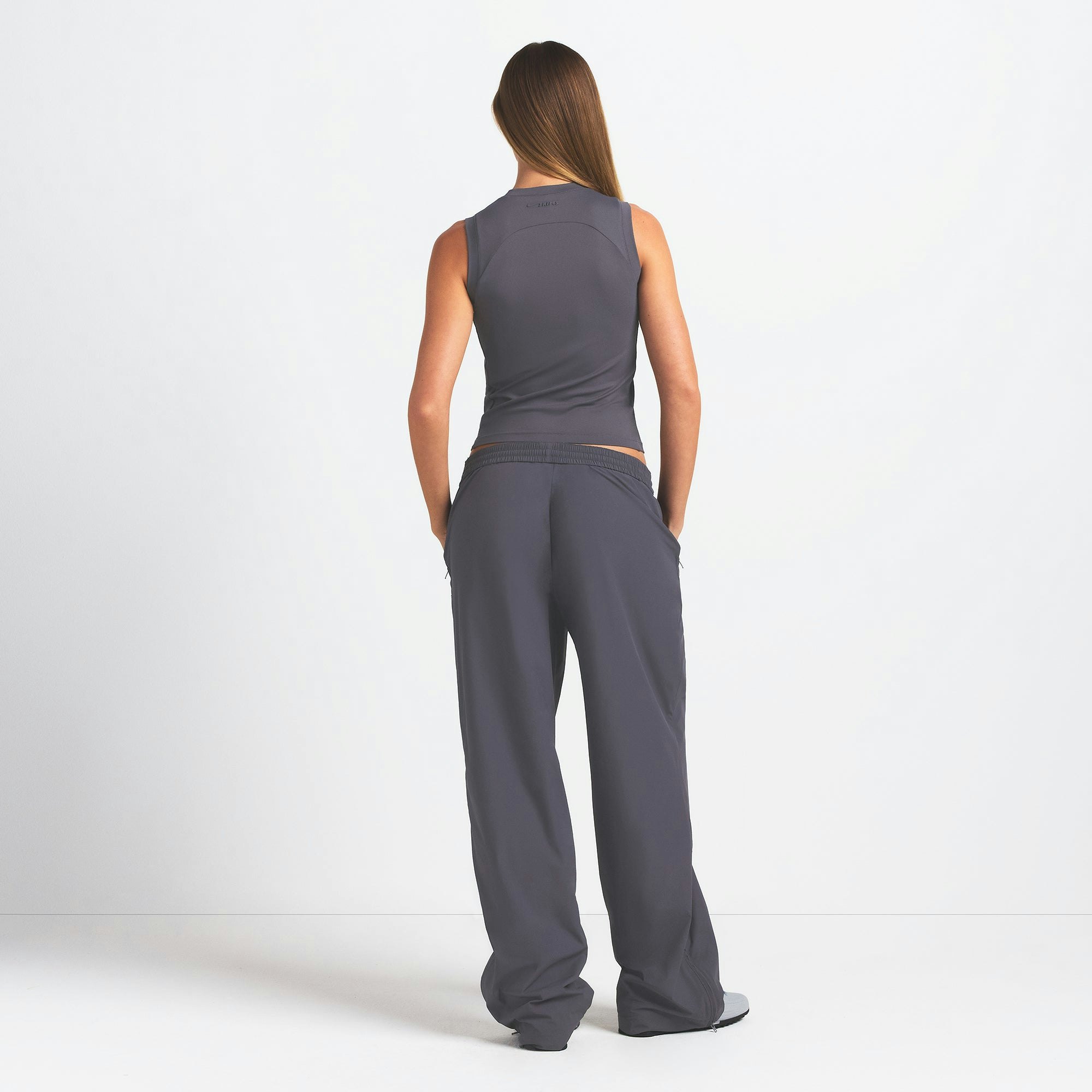 NikeSKIMS WOVEN NYLON OVERSIZED TRACK PANT | RAVEN ON A MODEL BACK VIEW @ | FOCUS: 0.0, 1.0, 0.9
