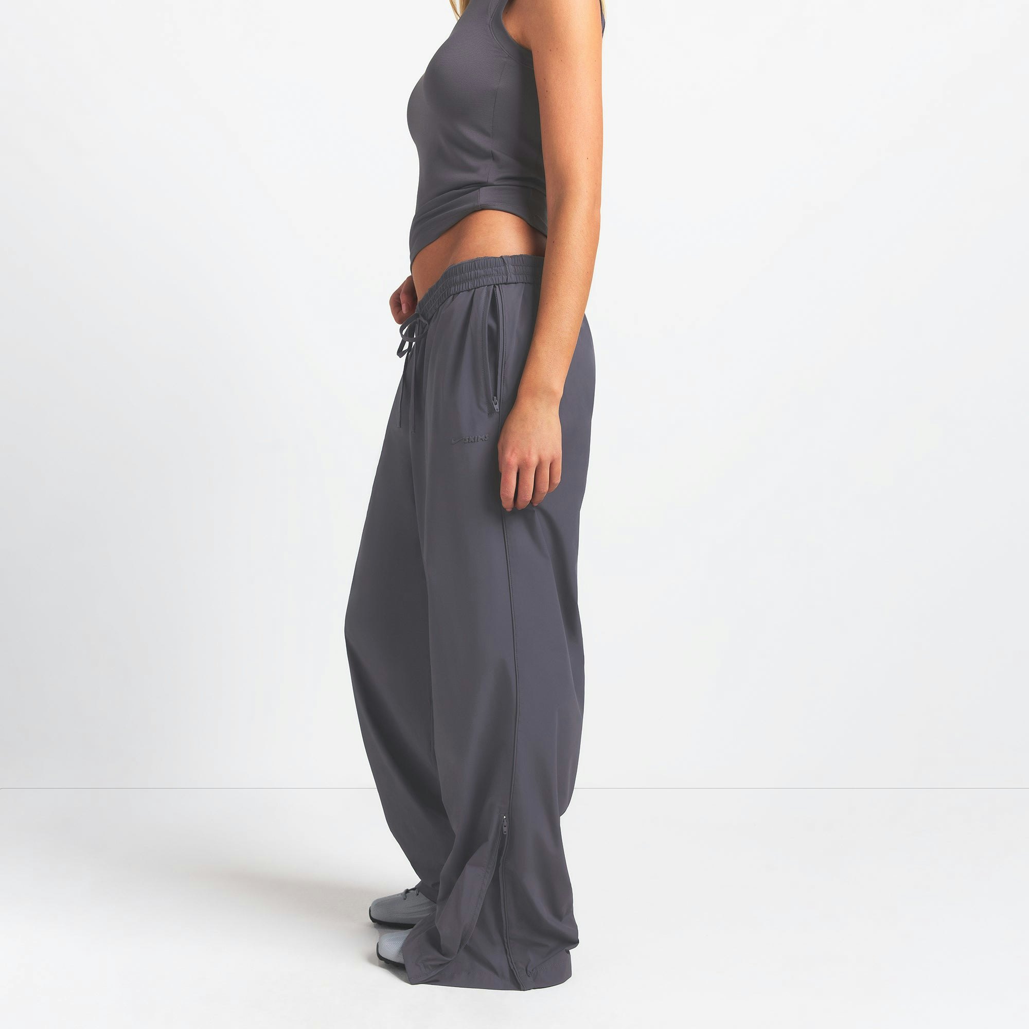 NikeSKIMS WOVEN NYLON OVERSIZED TRACK PANT | RAVEN ON A MODEL SIDE VIEW @ | FOCUS: 0.0, 1.0, 0.9