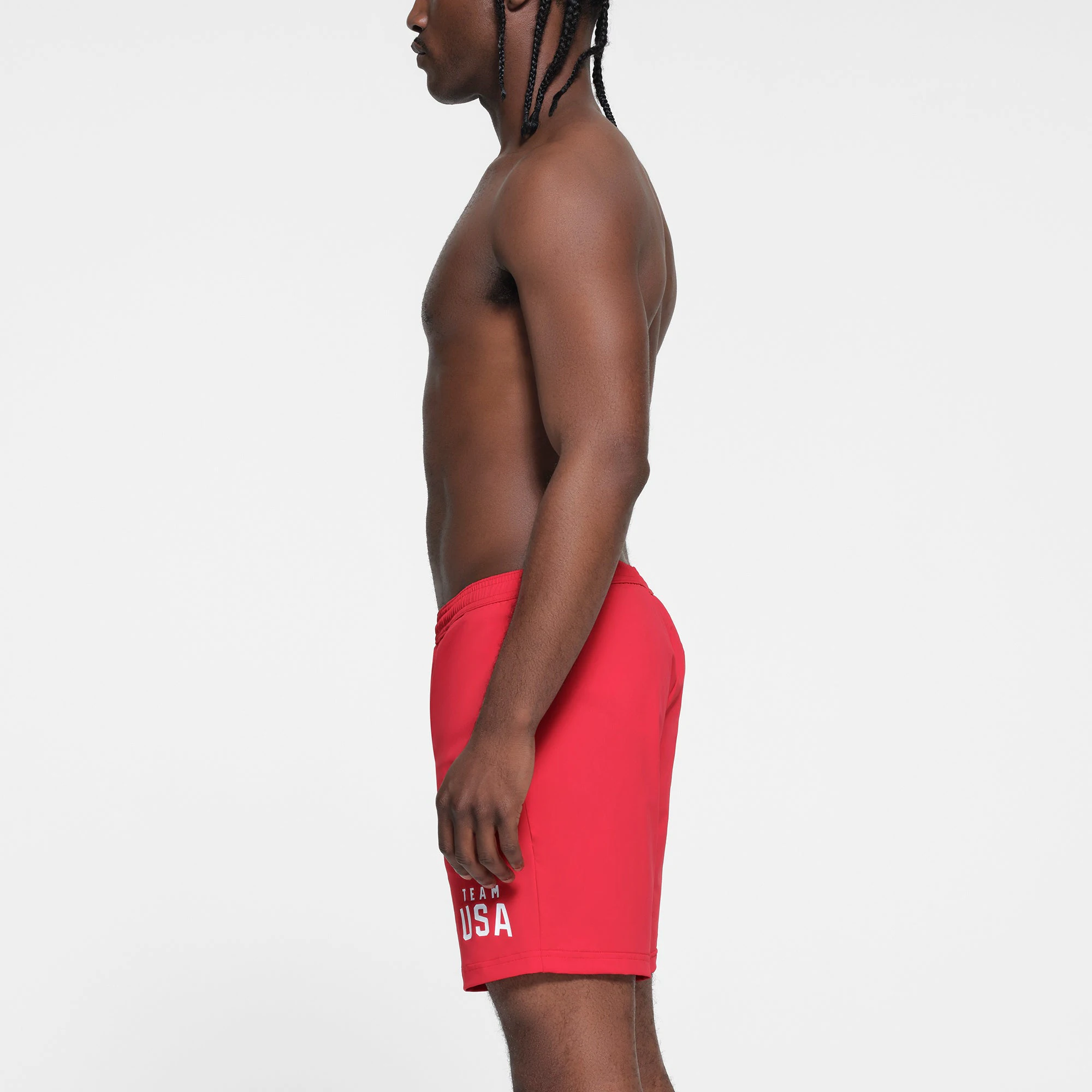 SKIMS FOR TEAM USA MENS OLYMPIC SWIM TRUNK | RED ON A MODEL SIDE VIEW