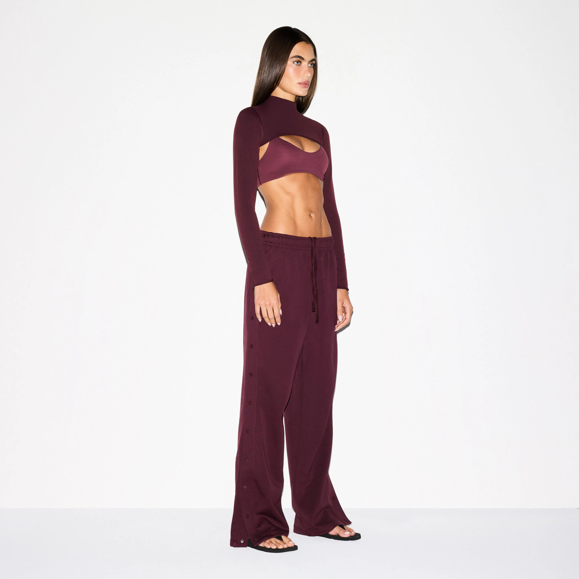 NikeSKIMS MATTE TRICOT SIDE SNAPS PANT | CURRANT ON A MODEL SIDE VIEW @ | FOCUS: 0.0, 1.0, 0.9