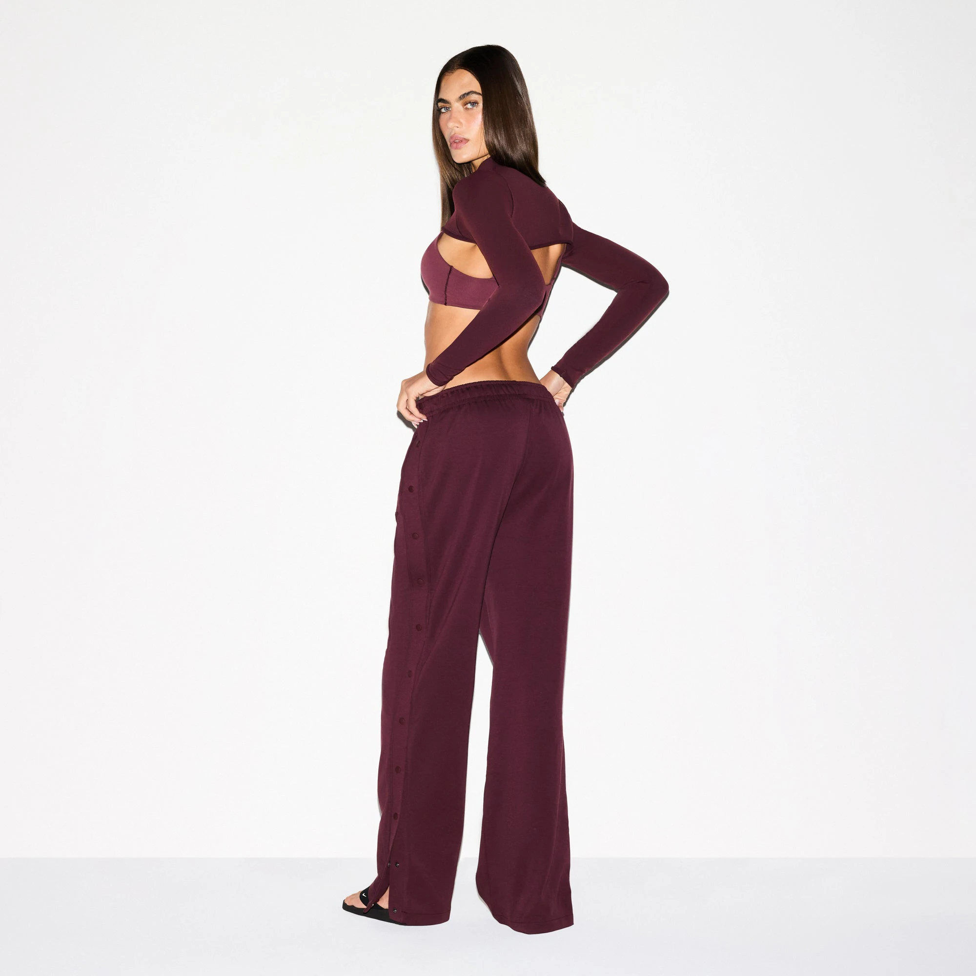 NikeSKIMS MATTE TRICOT SIDE SNAPS PANT | CURRANT ON A MODEL SIDE VIEW @ | FOCUS: 0.0, 1.0, 0.9