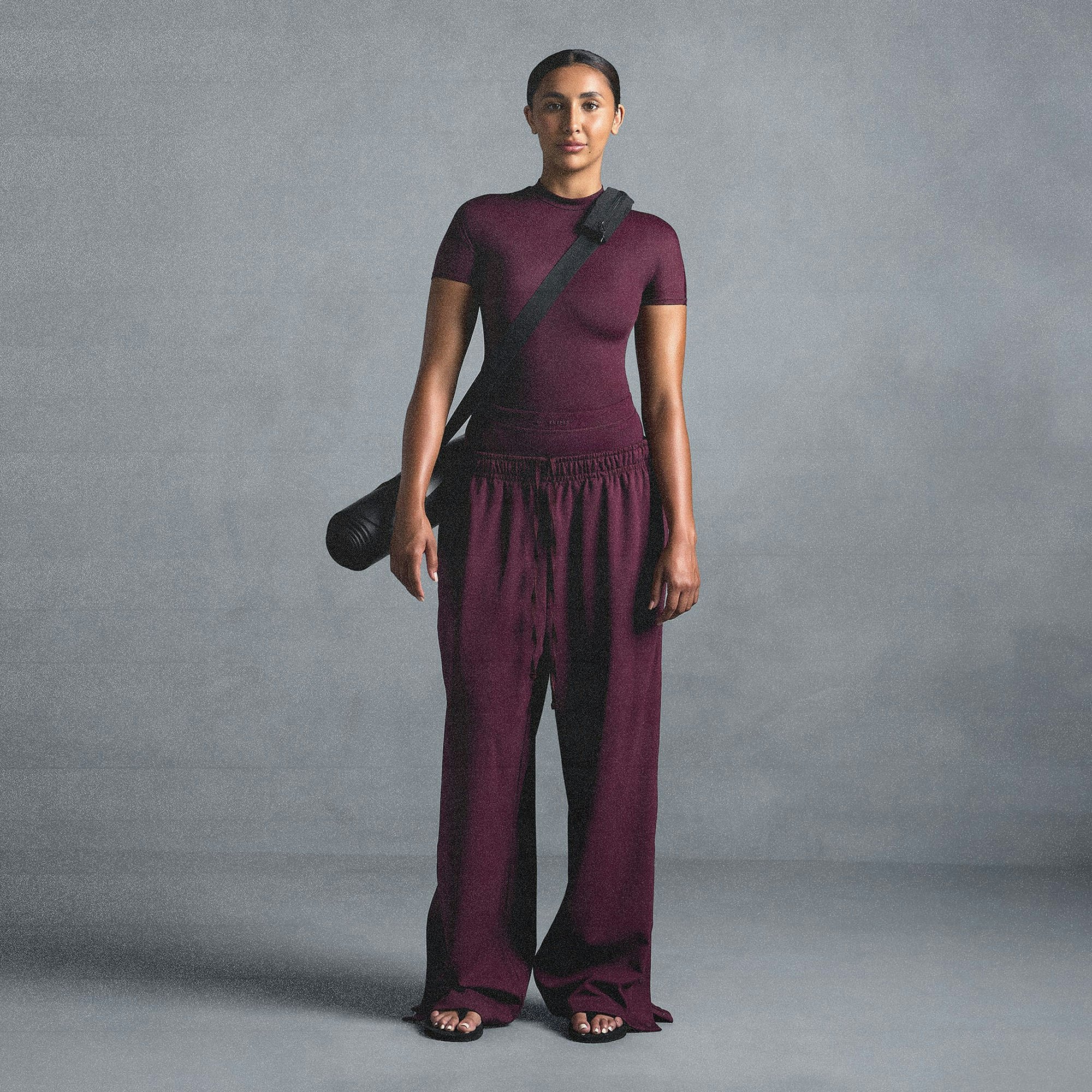 NikeSKIMS MATTE TRICOT SIDE SNAPS PANT | CURRANT ON A MODEL SIDE VIEW @ | FOCUS: 0.0, 1.0, 0.9