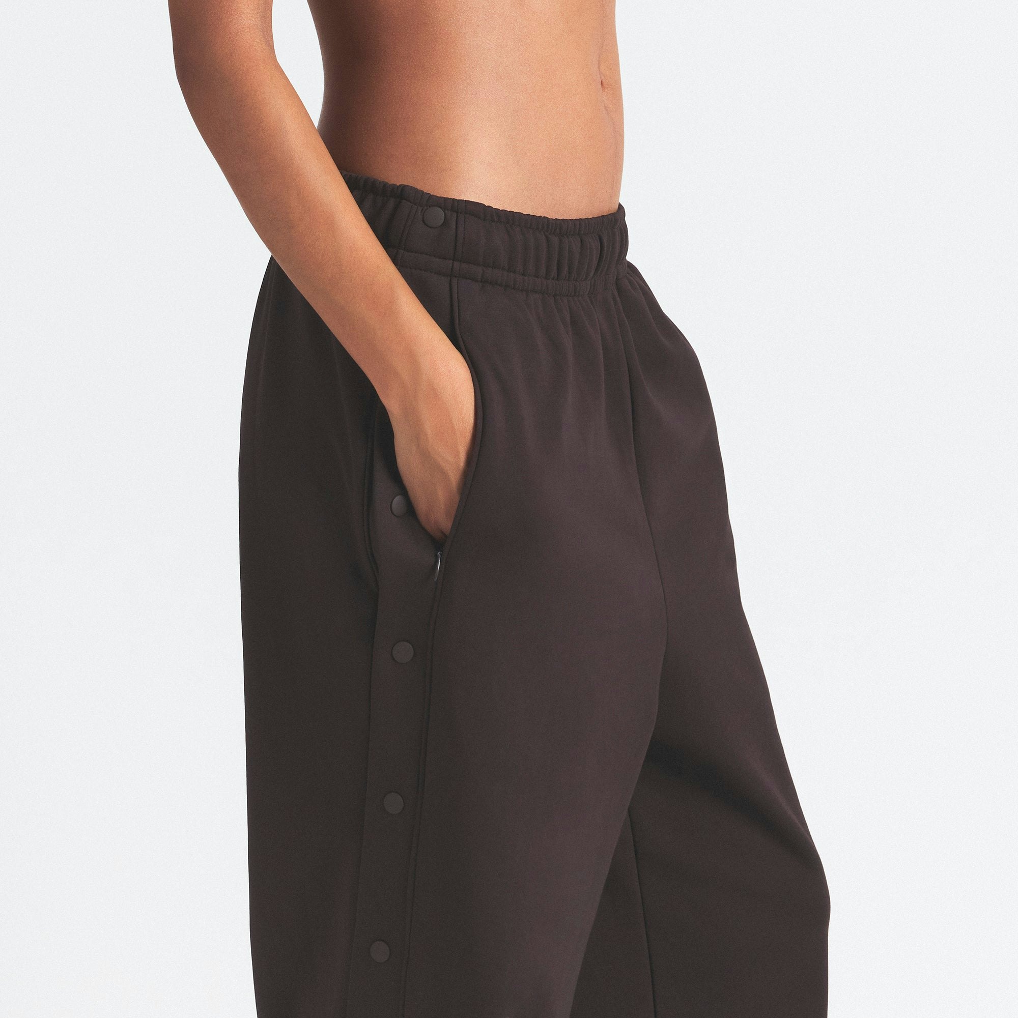 NikeSKIMS MATTE TRICOT SIDE SNAPS PANT | DARK ROAST ON A MODEL SIDE VIEW @ | FOCUS: 0.0, 1.0, 0.9