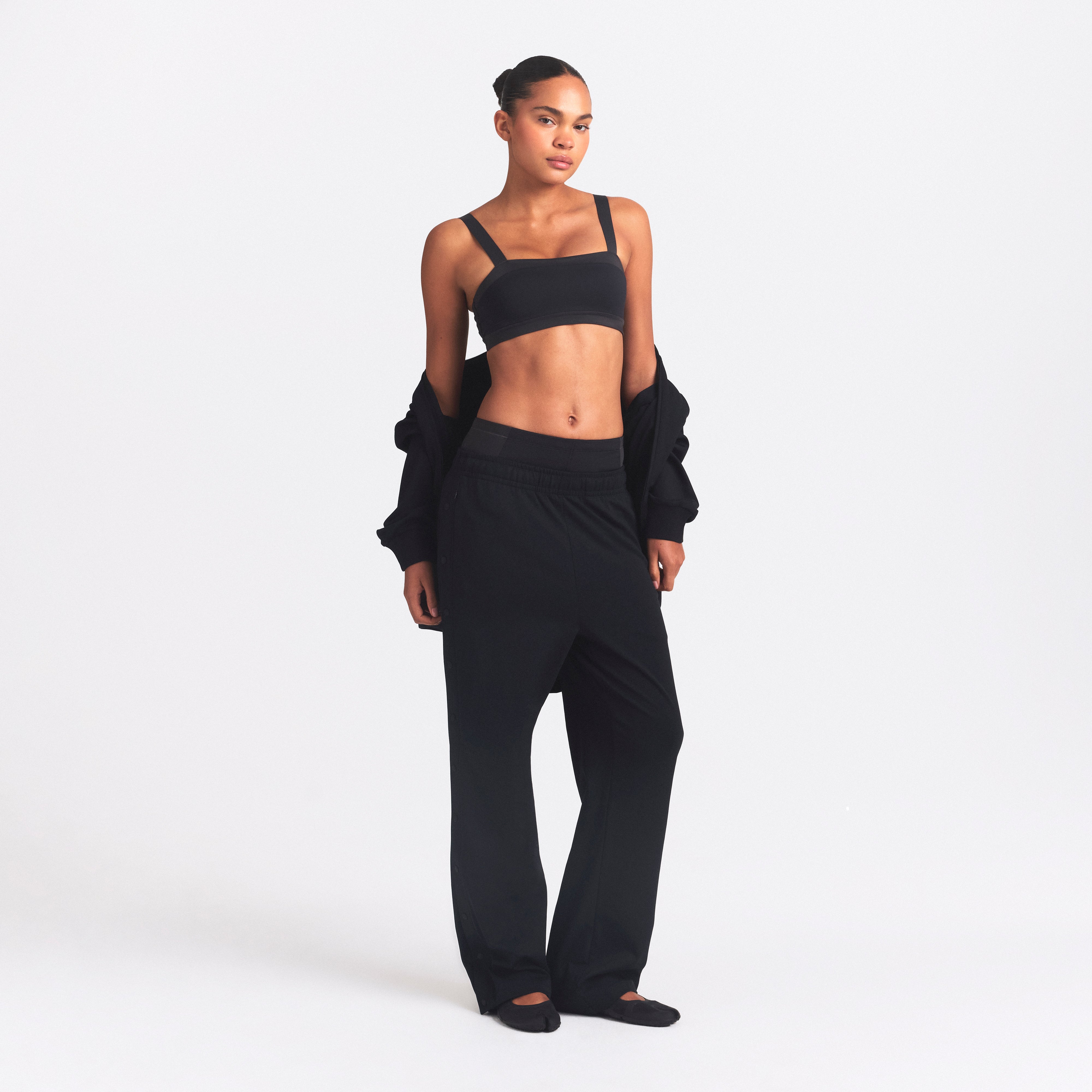 NikeSKIMS MATTE TRICOT SIDE SNAPS PANT | OBSIDIAN ON A MODEL FRONT VIEW @ | FOCUS: 0.0, 1.0, 0.9