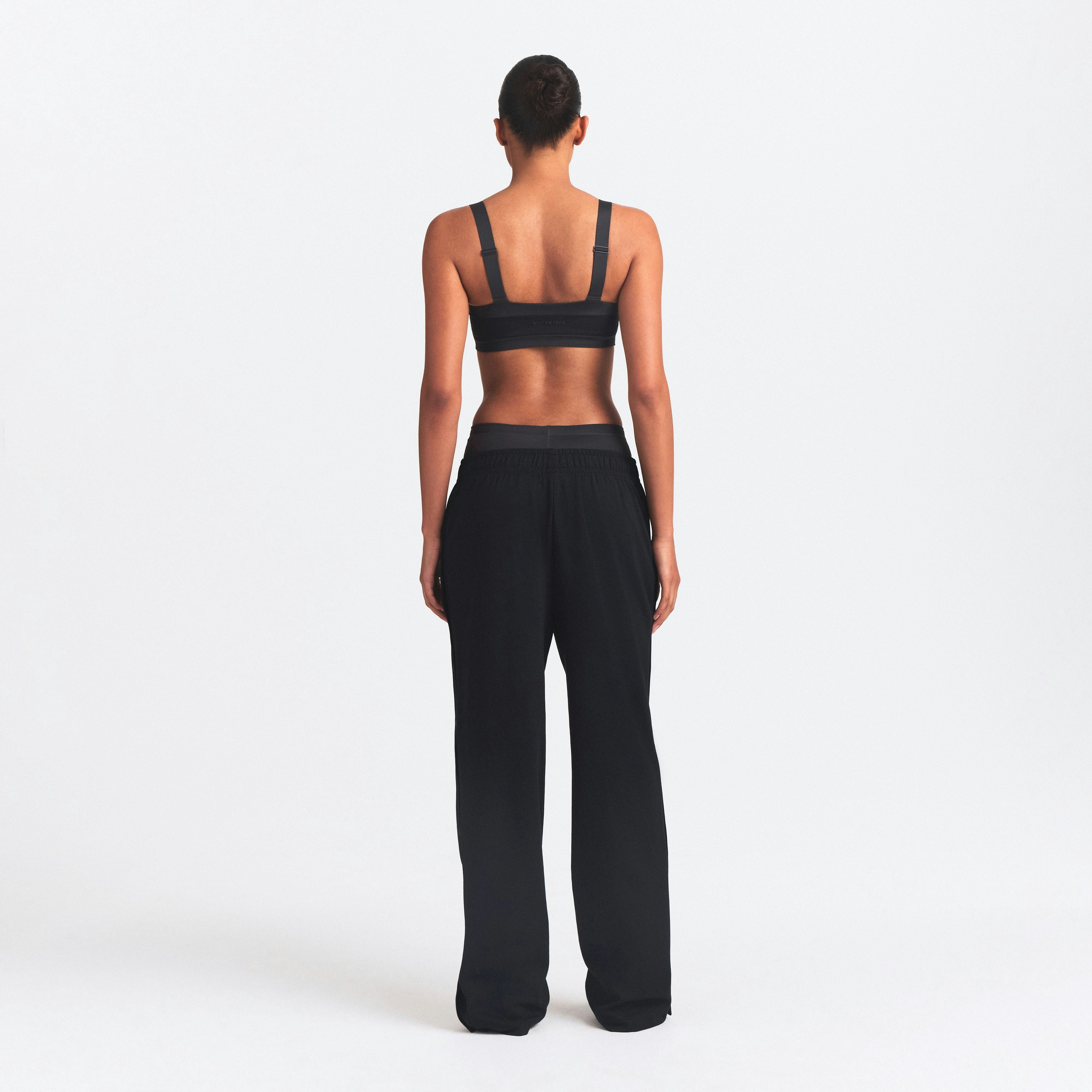 NikeSKIMS MATTE TRICOT SIDE SNAPS PANT | OBSIDIAN ON A MODEL SIDE VIEW @ | FOCUS: 0.0, 1.0, 0.9