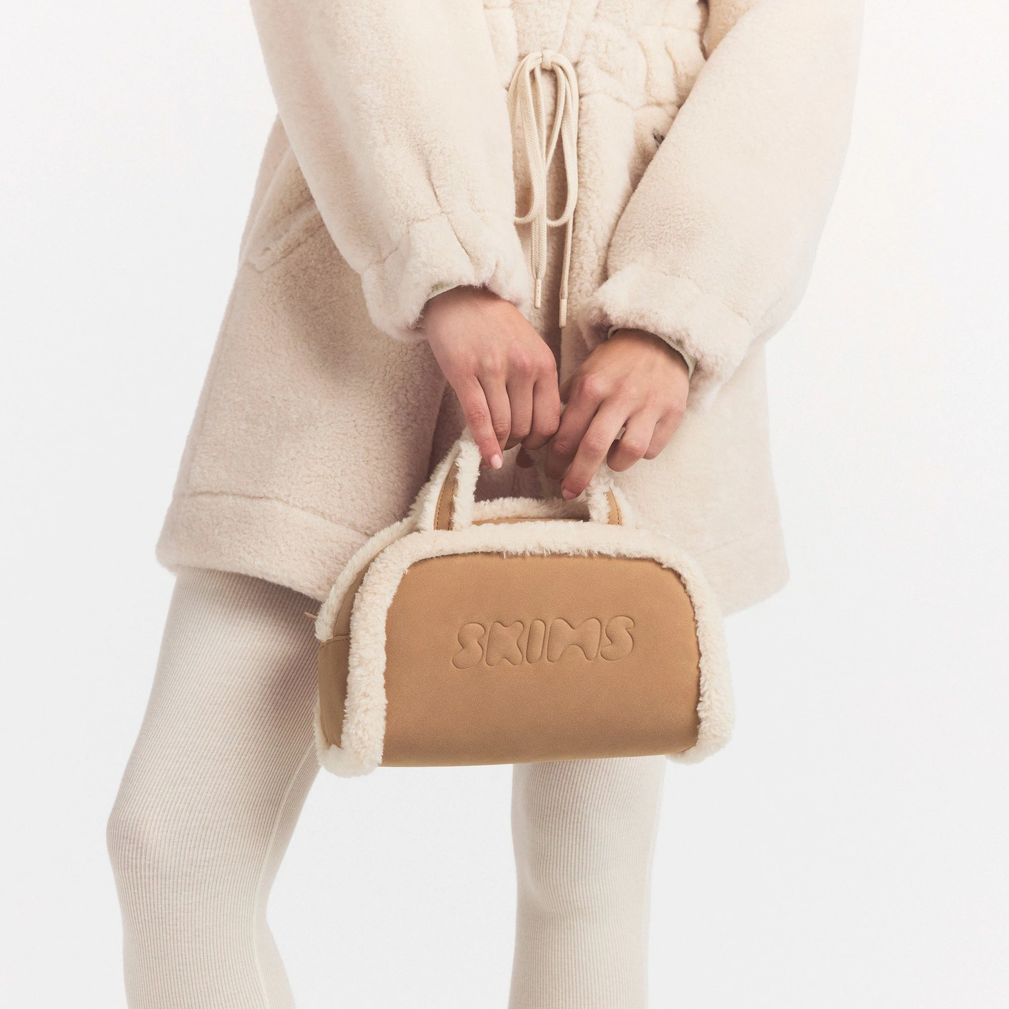 FAUX SHEARLING MINI DUFFLE | CLAY SHERPA ON A MODEL SIDE VIEW @ | FOCUS: 0.0, 1.0, 0.9