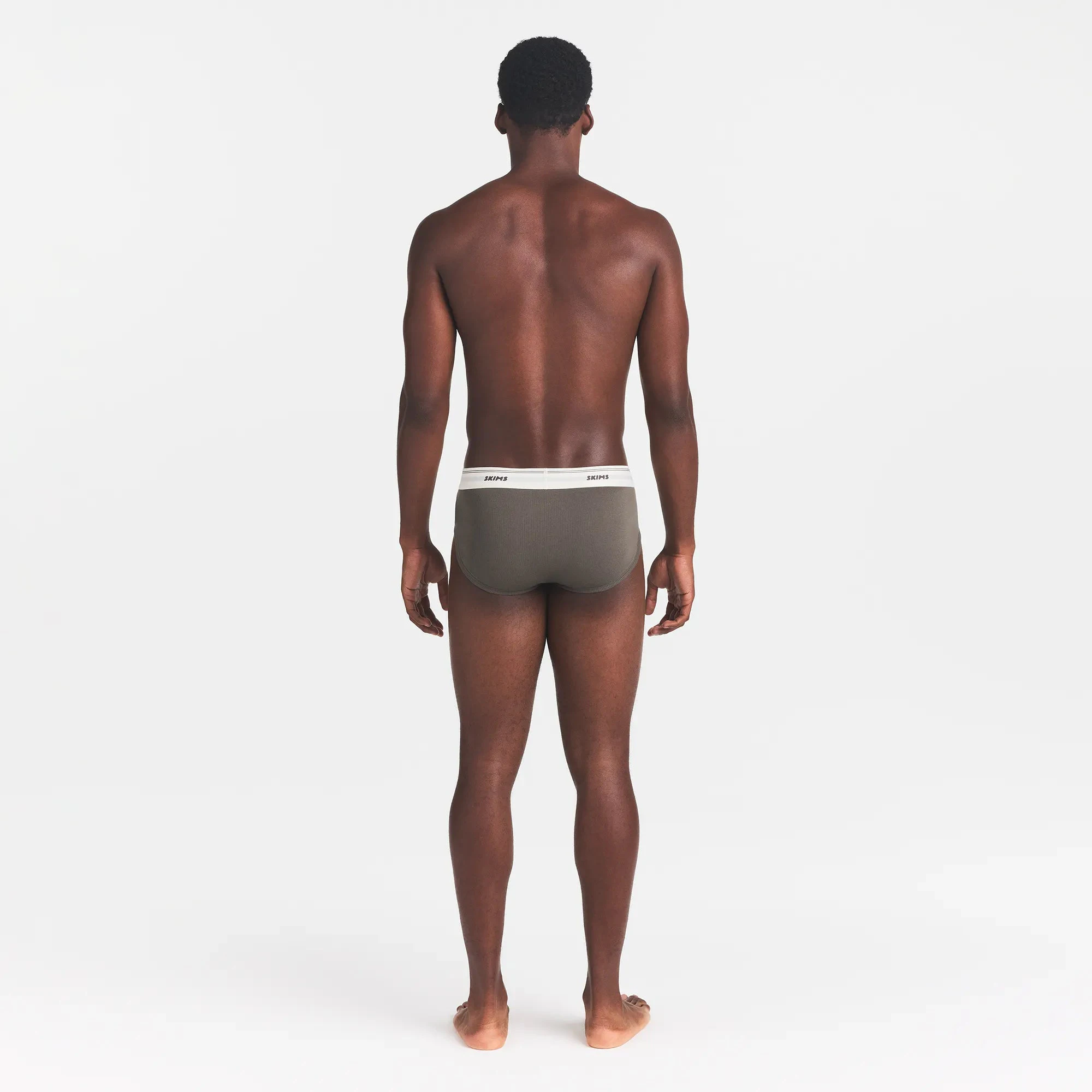 SKIMS COTTON RIB MENS BRIEF | JUNGLE ON A MODEL BACK VIEW @ | FOCUS: 0.0, 1.0, 0.9