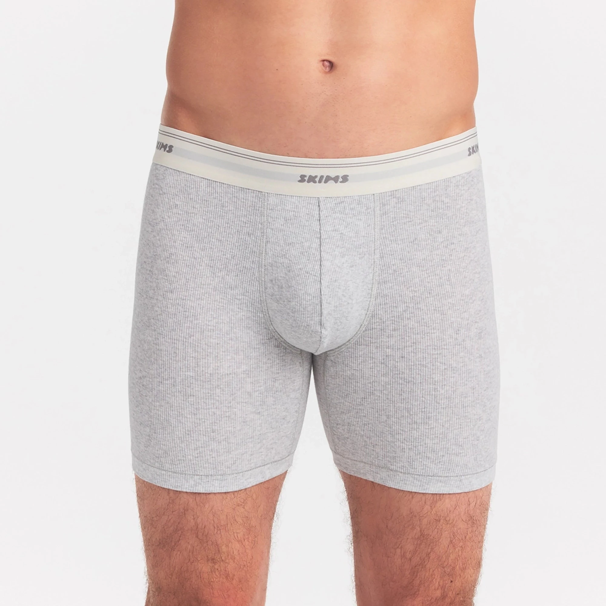 SKIMS COTTON RIB MENS 5" BOXER BRIEF | LIGHT HEATHER GREY ON A MODEL SIDE VIEW @ | FOCUS: 0.0, 1.0, 0.9