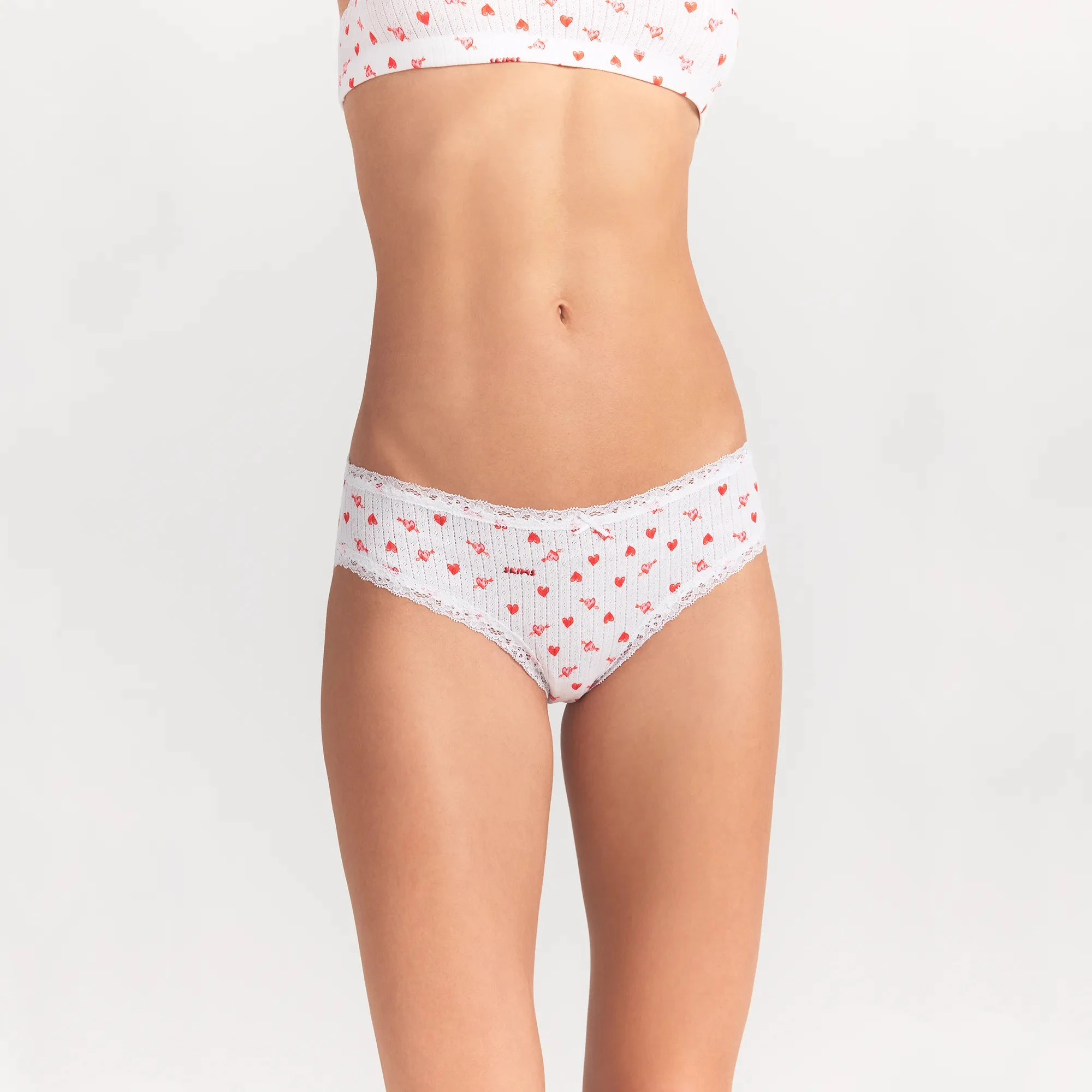 LIGHTWEIGHT COTTON POINTELLE LACE BRIEF | SNOW ARROWED HEARTS ON A MODEL FRONT VIEW @ | FOCUS: 0.0, 1.0, 0.9