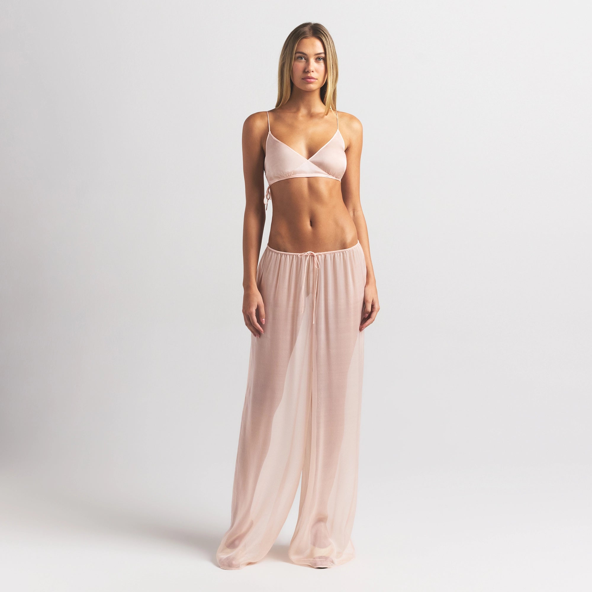 SKIMS ROMANCE SKIMPY WRAP BRALETTE | PRIMROSE ON A MODEL FRONT VIEW @ | FOCUS: 0.0, 1.0, 0.9