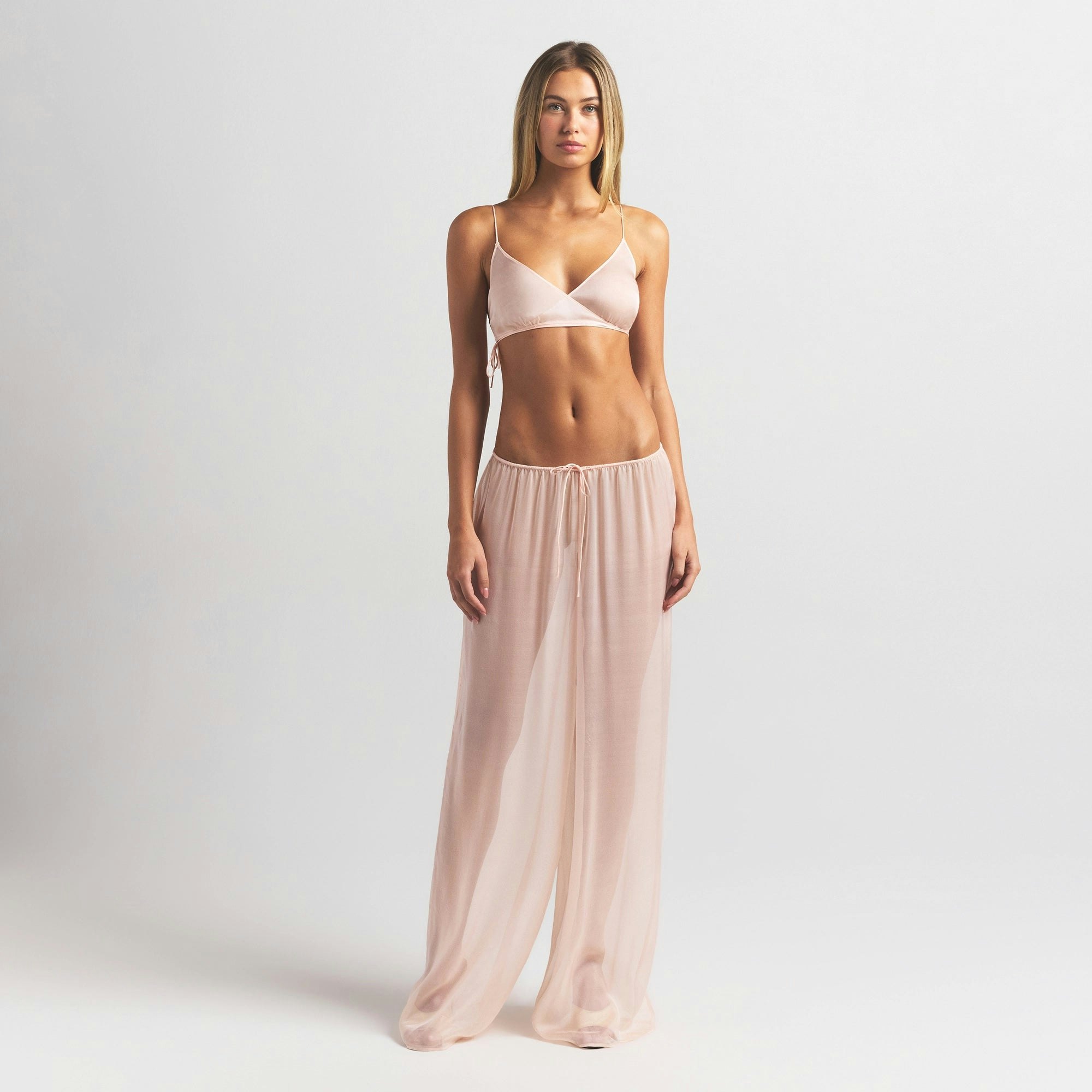 SKIMS ROMANCE SKIMPY WRAP BRALETTE | PRIMROSE ON A MODEL FRONT VIEW @ | FOCUS: 0.0, 1.0, 0.9