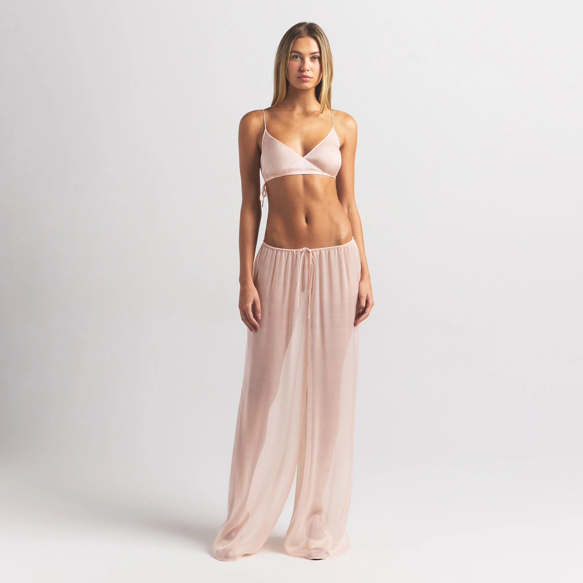 SKIMS ROMANCE SKIMPY WRAP BRALETTE | PRIMROSE ON A MODEL FRONT VIEW @ | FOCUS: 0.0, 1.0, 0.9