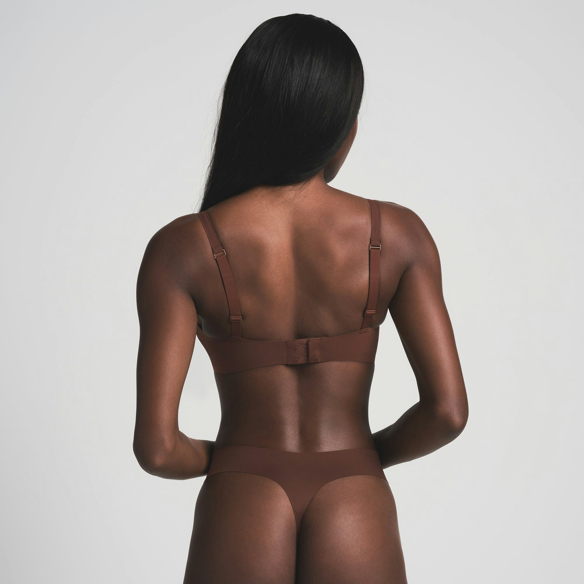 NAKED PLUNGE BRA WORN BY A MODEL IN BACK VIEW