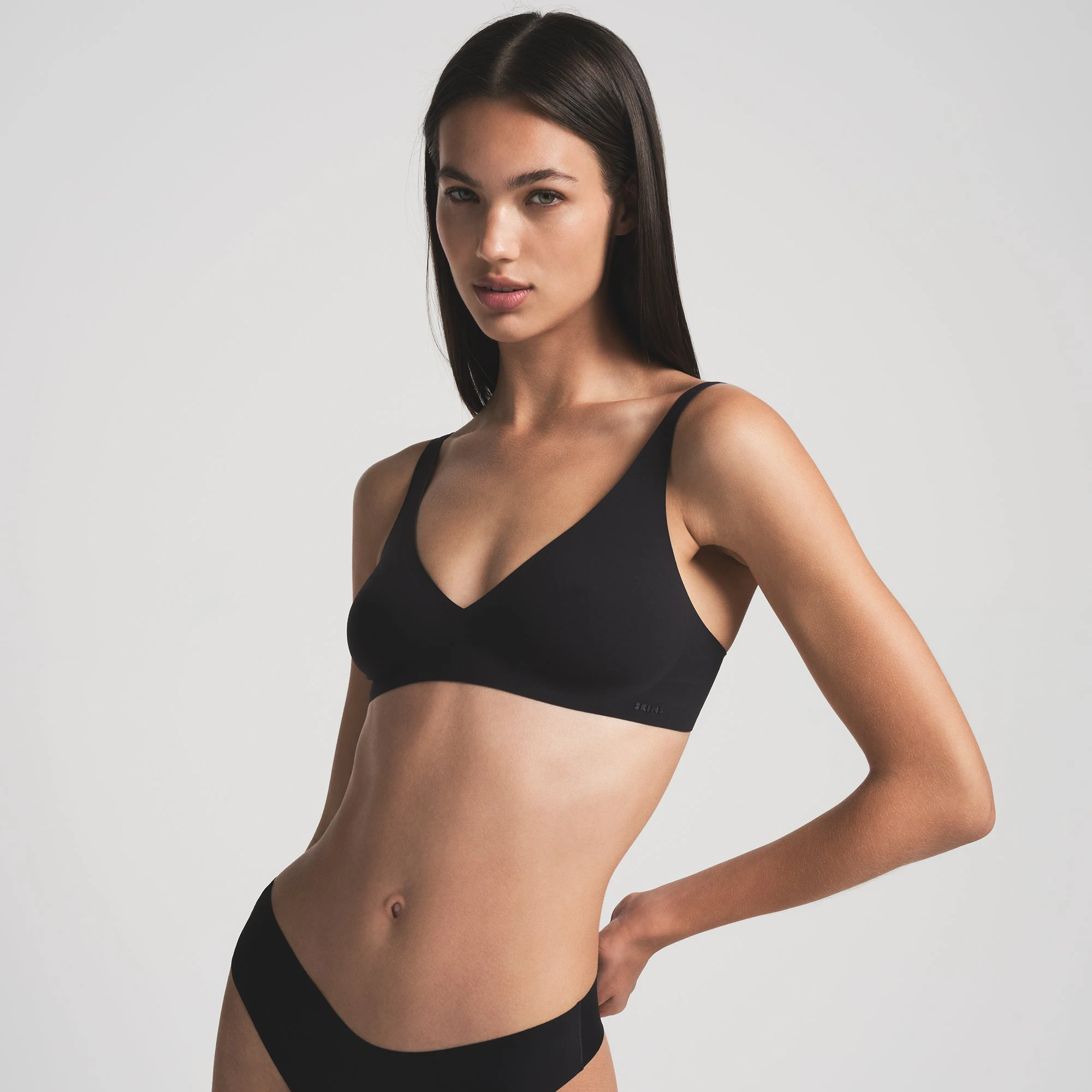 NAKED PLUNGE BRA WORN BY A MODEL IN FRONT VIEW