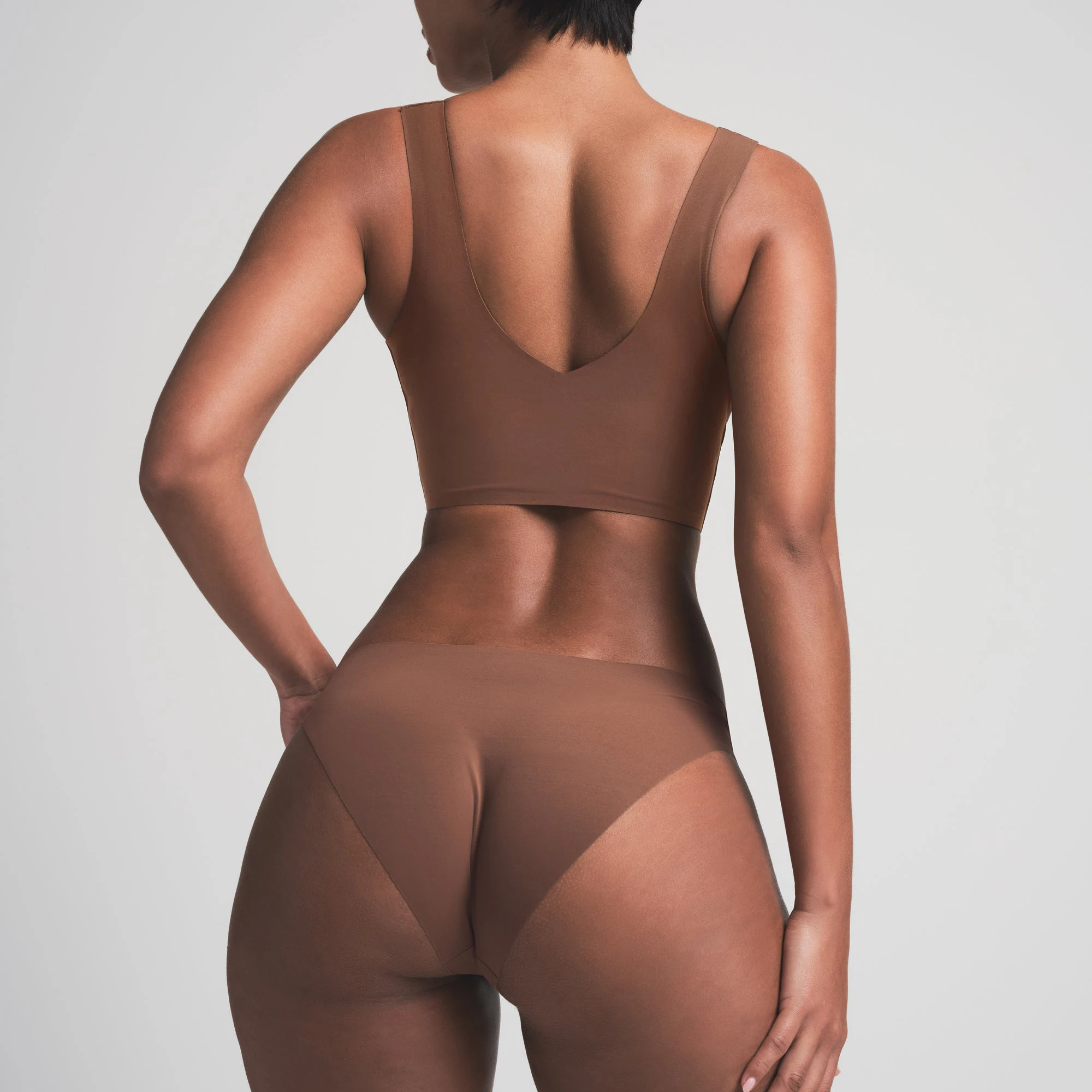 NAKED PLUNGE LONGLINE BRA WORN BY A MODEL IN FRONT VIEW 