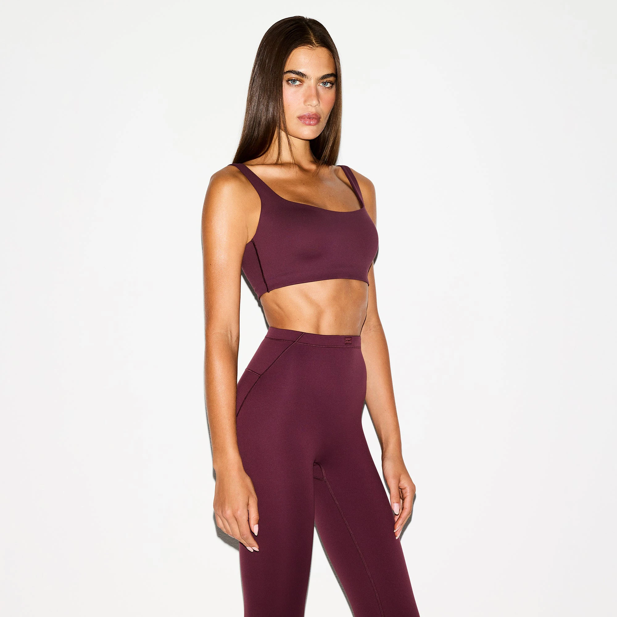 NikeSKIMS MATTE SCOOP NECK BRA | CURRANT ON A MODEL SIDE VIEW @ | FOCUS: 0.0, 1.0, 0.9