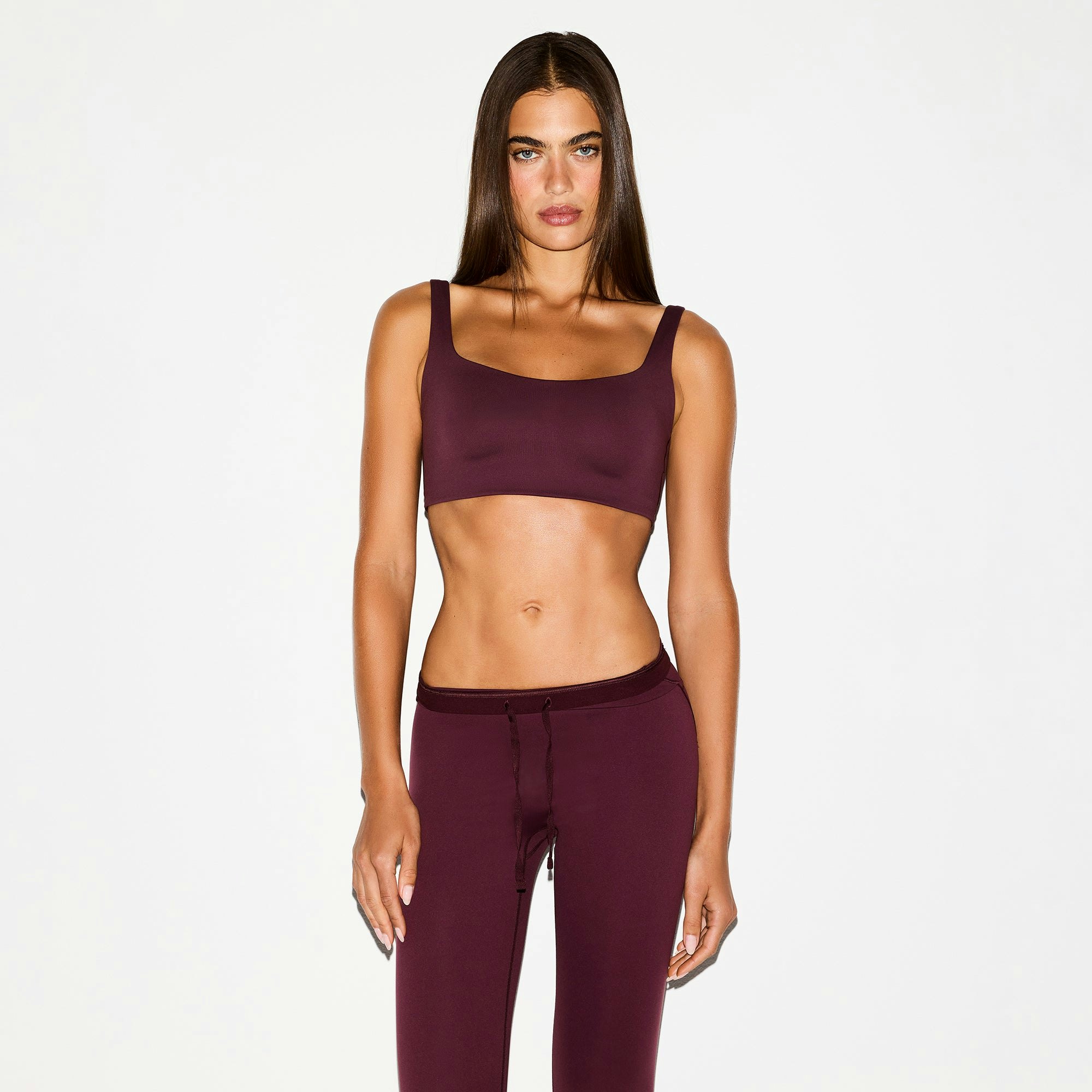 NikeSKIMS MATTE SCOOP NECK BRA | CURRANT ON A MODEL FRONT VIEW @ | FOCUS: 0.0, 1.0, 0.9