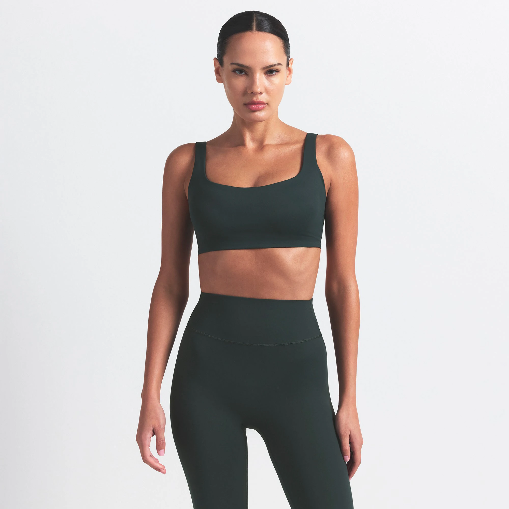 NikeSKIMS MATTE SCOOP NECK BRA | DARK TEAL ON A MODEL SIDE VIEW @ | FOCUS: 0.0, 1.0, 0.9