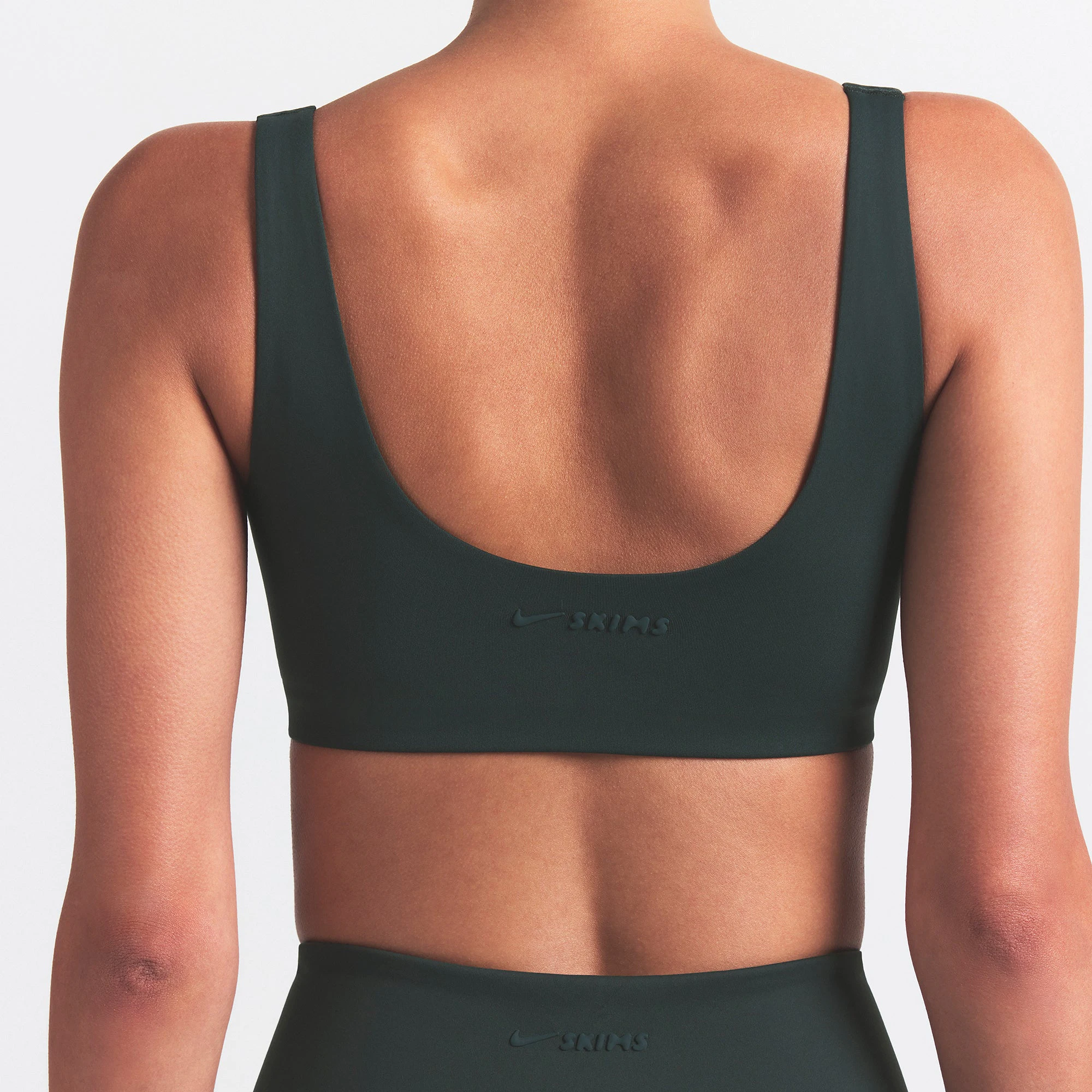 NikeSKIMS MATTE SCOOP NECK BRA | DARK TEAL ON A MODEL SIDE VIEW @ | FOCUS: 0.0, 1.0, 0.9