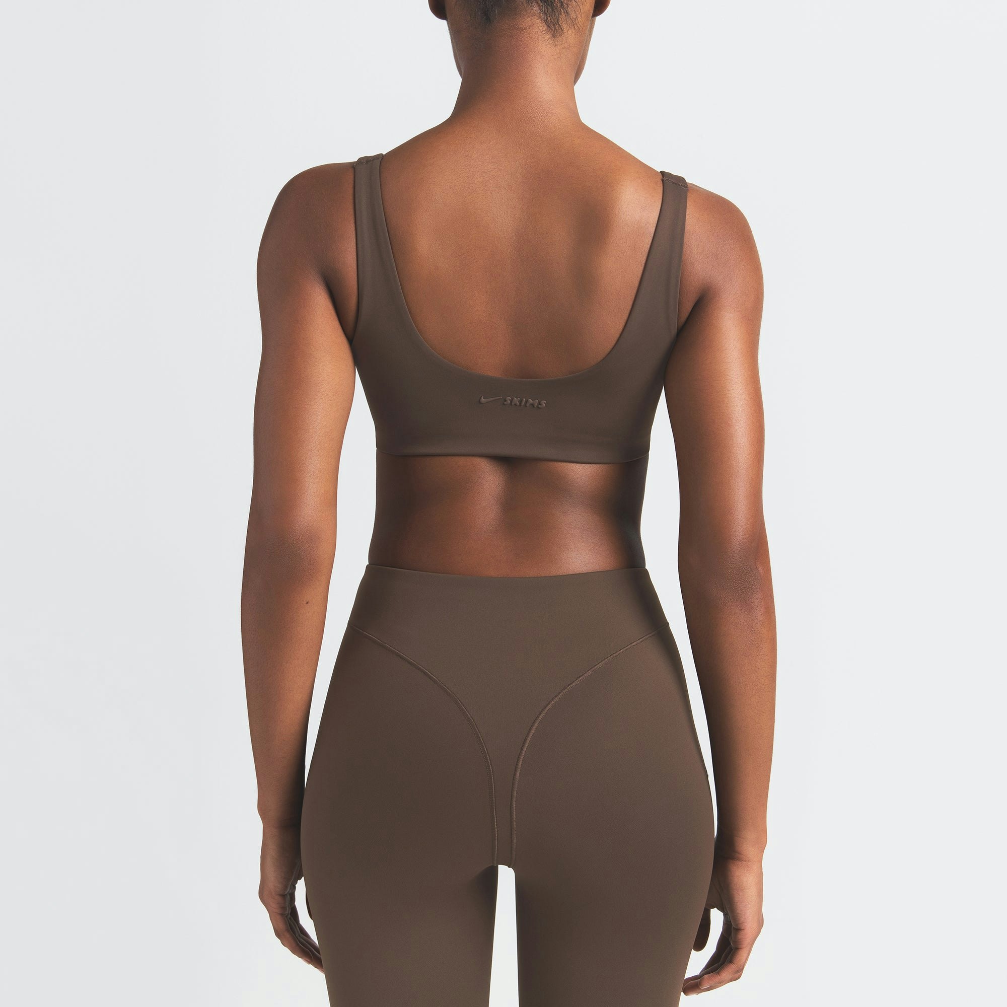 NikeSKIMS MATTE SCOOP NECK BRA | DARK SEPIA ON A MODEL BACK VIEW