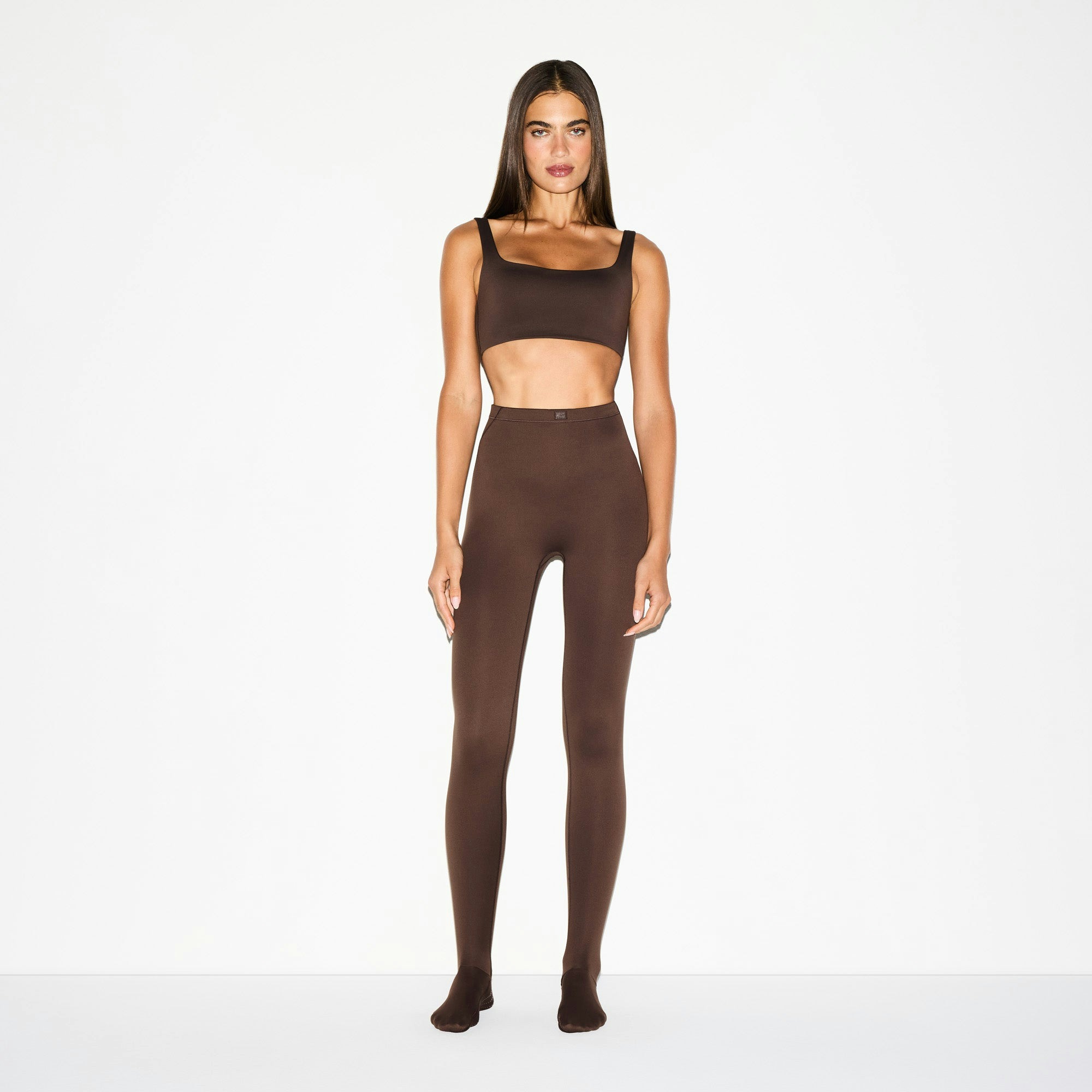 NikeSKIMS MATTE SCOOP NECK BRA | DARK SEPIA ON A MODEL FRONT VIEW @ | FOCUS: 0.0, 1.0, 0.9